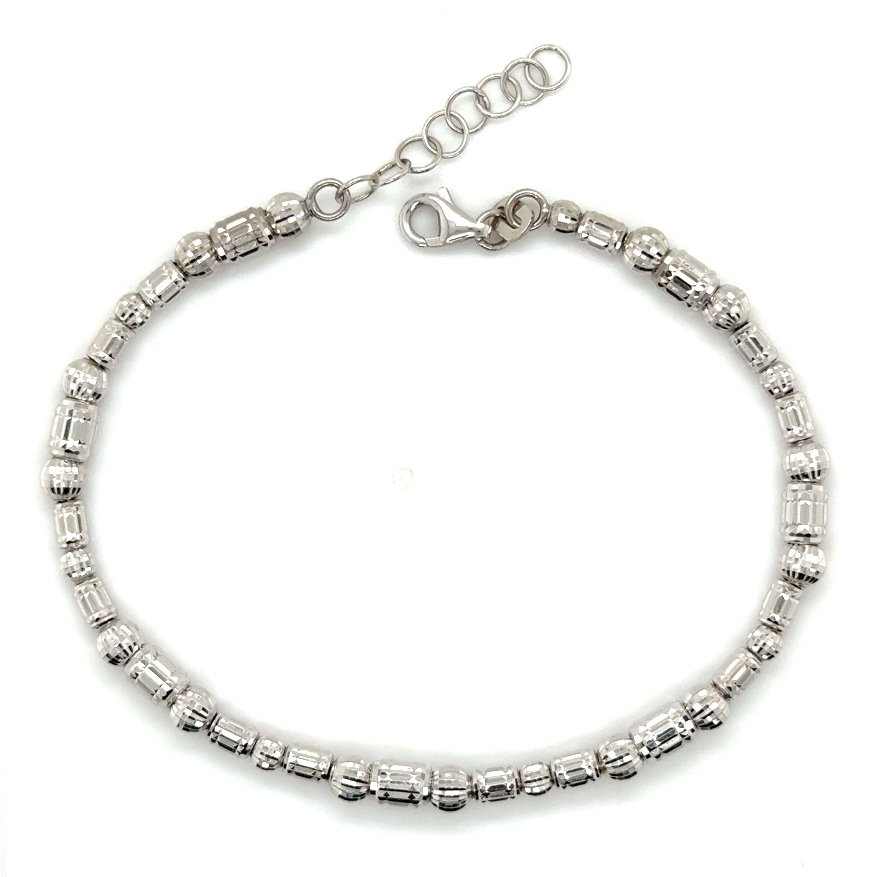 This 14K White Gold Barrel Bead Bracelet features shimmering diamond cut beads crafted from genuine gold, offering lasting shine and durability.
