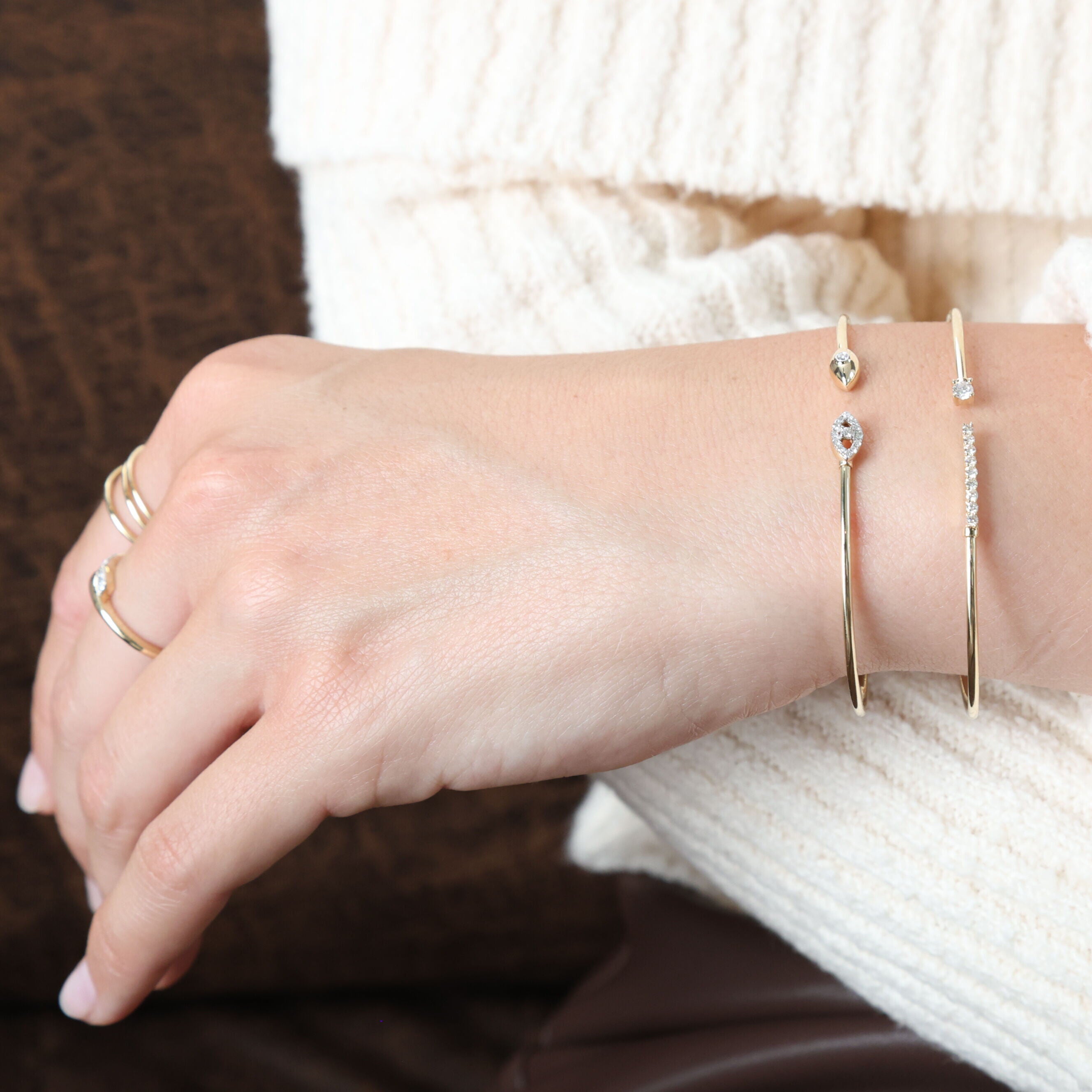 This 14K Yellow Gold Diamond Bangle Bracelet pairs beautifully with a cozy sweater, adding a sophisticated and sparkling touch to a casual look. Perfect for elevating everyday style or as a gift for a loved one.