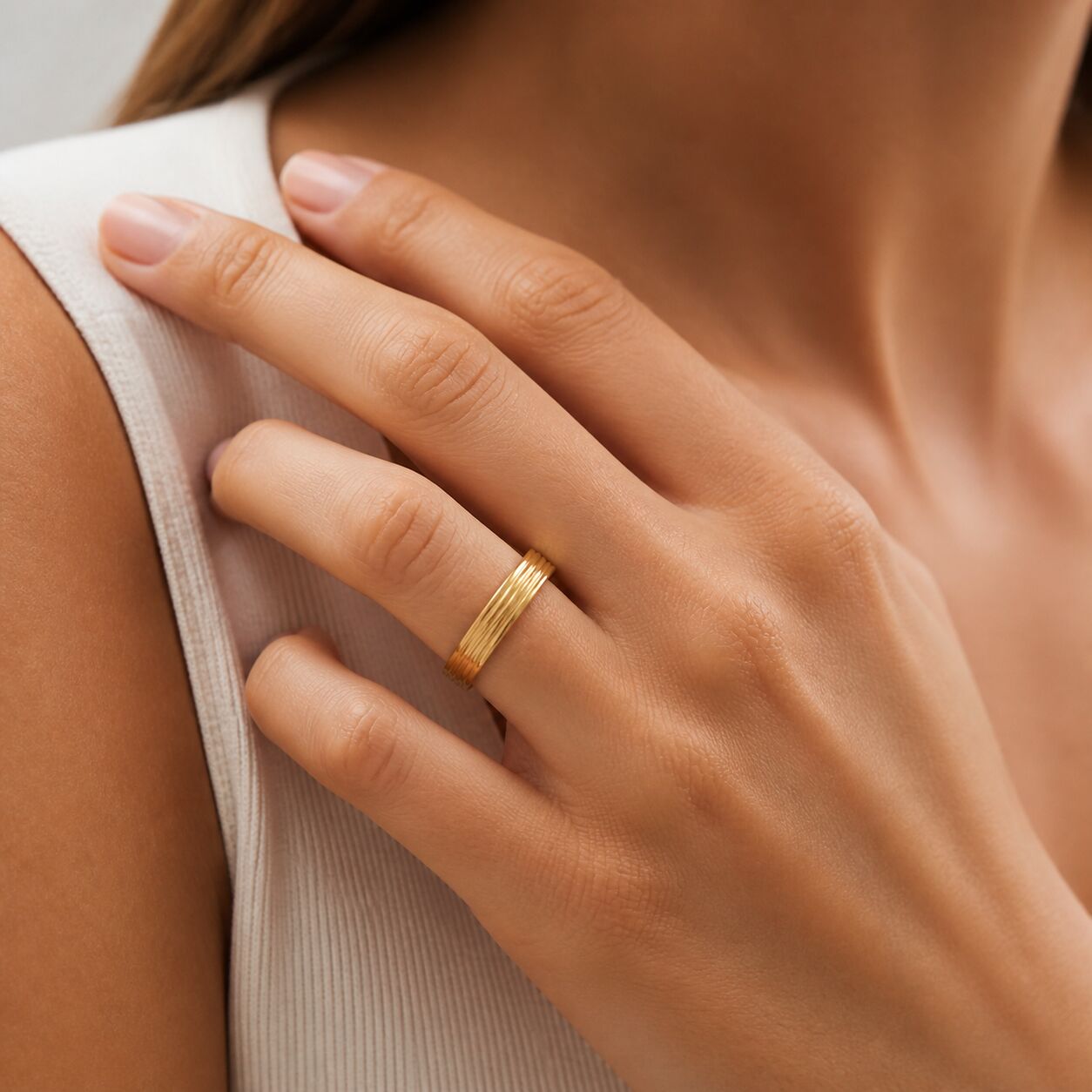 Model wearing 14K yellow gold grooved multi-band ring, 4mm gold stacking ring