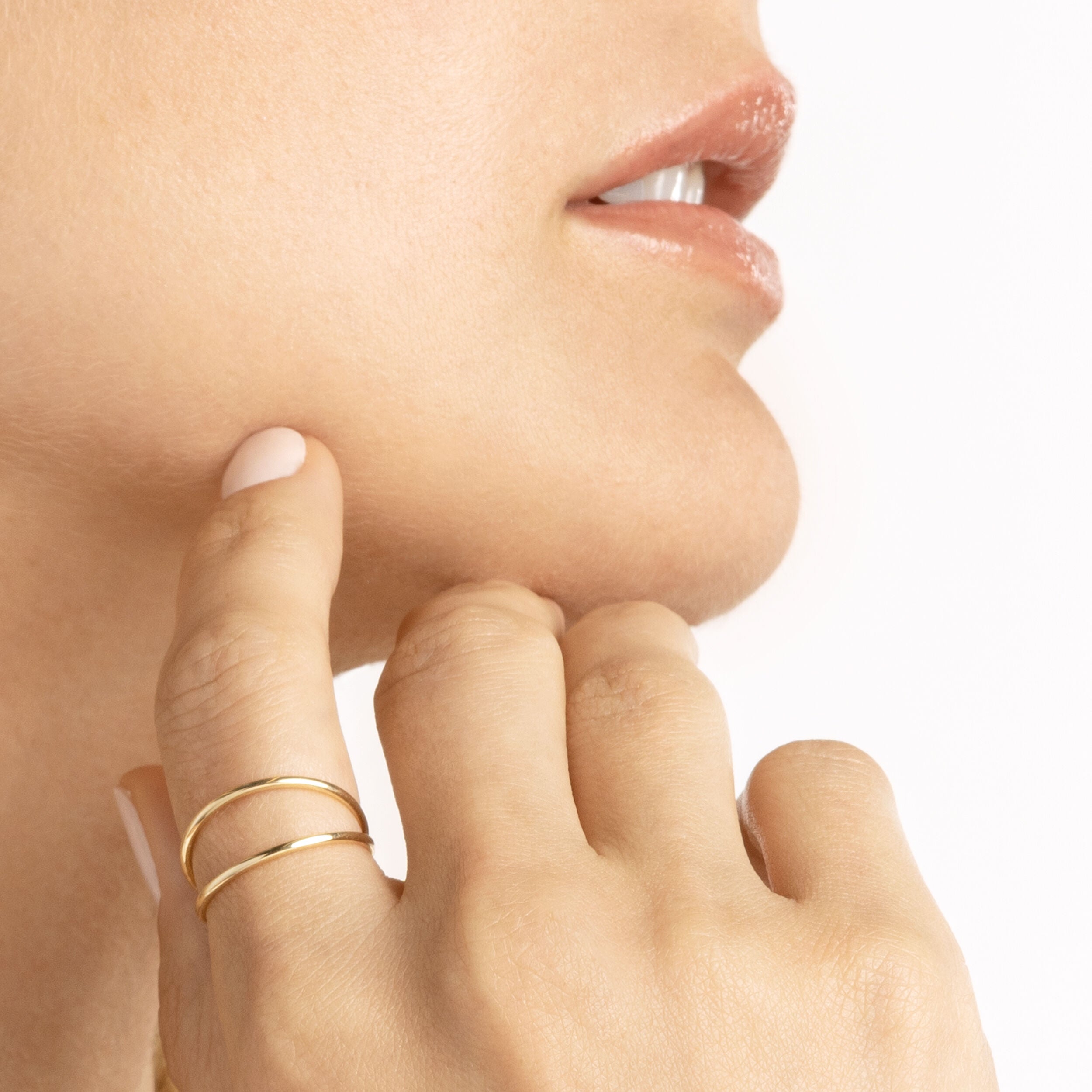 14K yellow gold stackable double band ring worn on finger with polished double wire detail