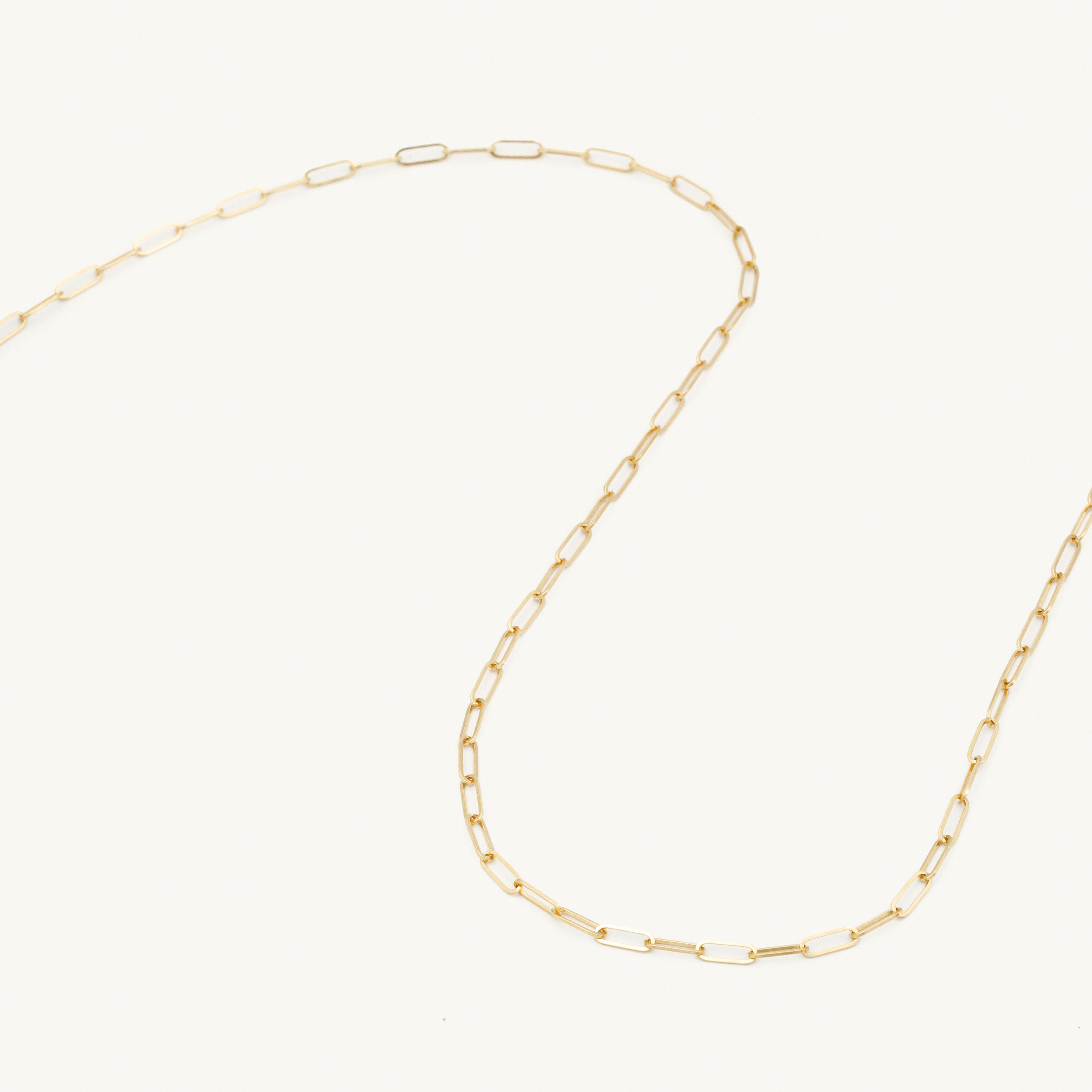 Paperclip link necklace in yellow gold adds a trendy edge to casual looks.