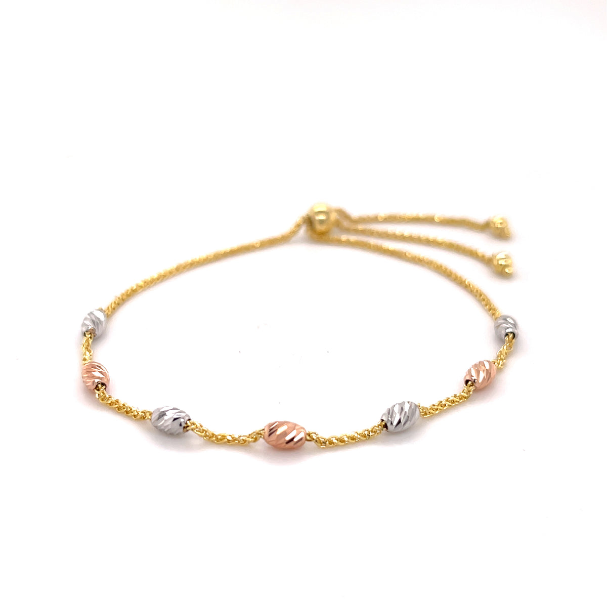14K tricolor gold diamond-cut beaded friendship bracelet coiled on white background, adjustable to 9.25 inches