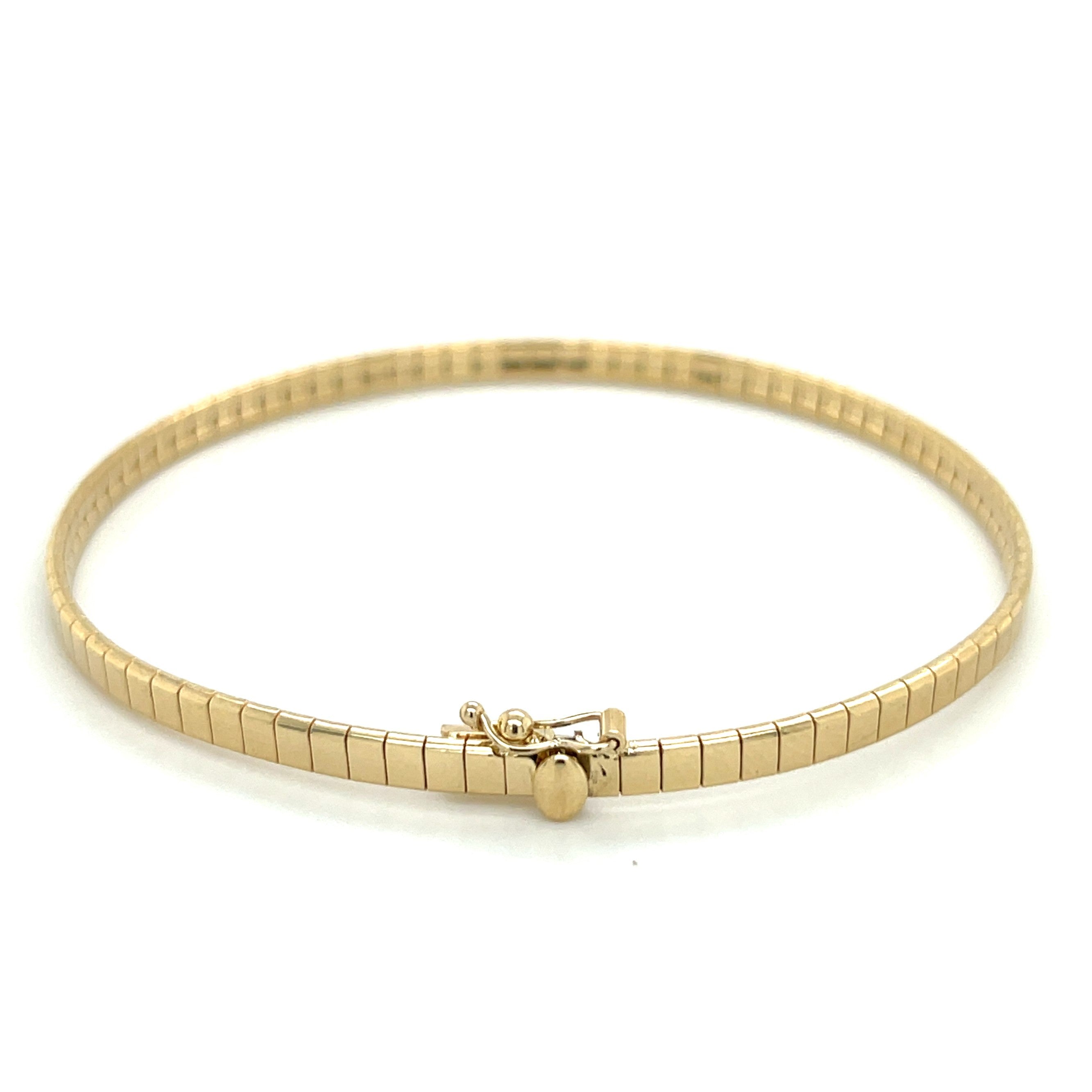 14K yellow gold omega bracelet featuring a square segment design. Measuring 7" long and 3.2mm wide, secured with a box clasp.