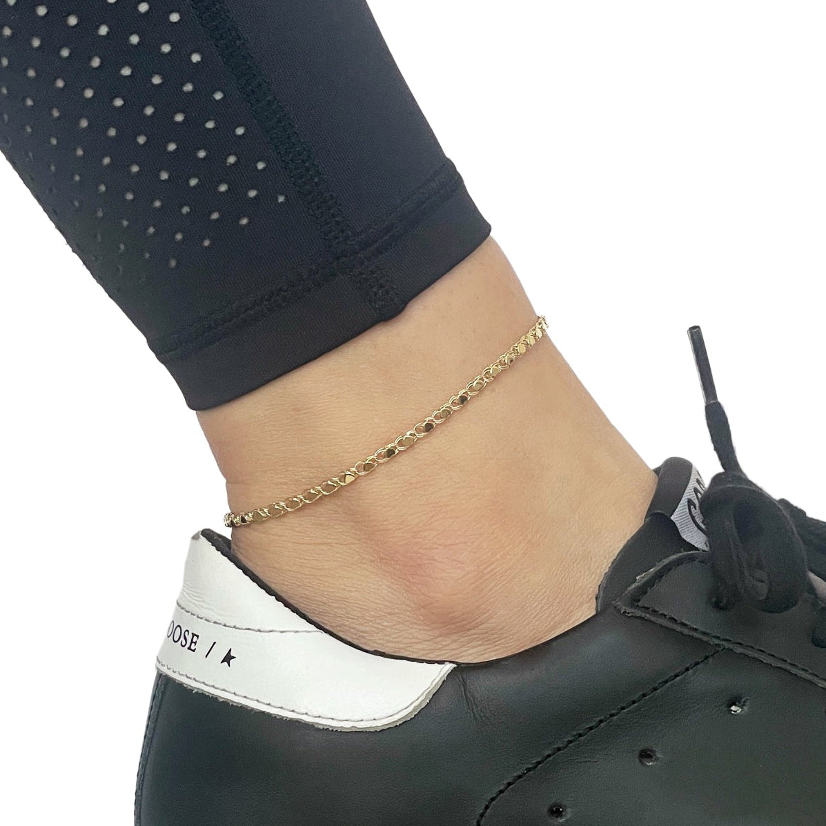 14k yellow gold heart link anklet on woman's ankle