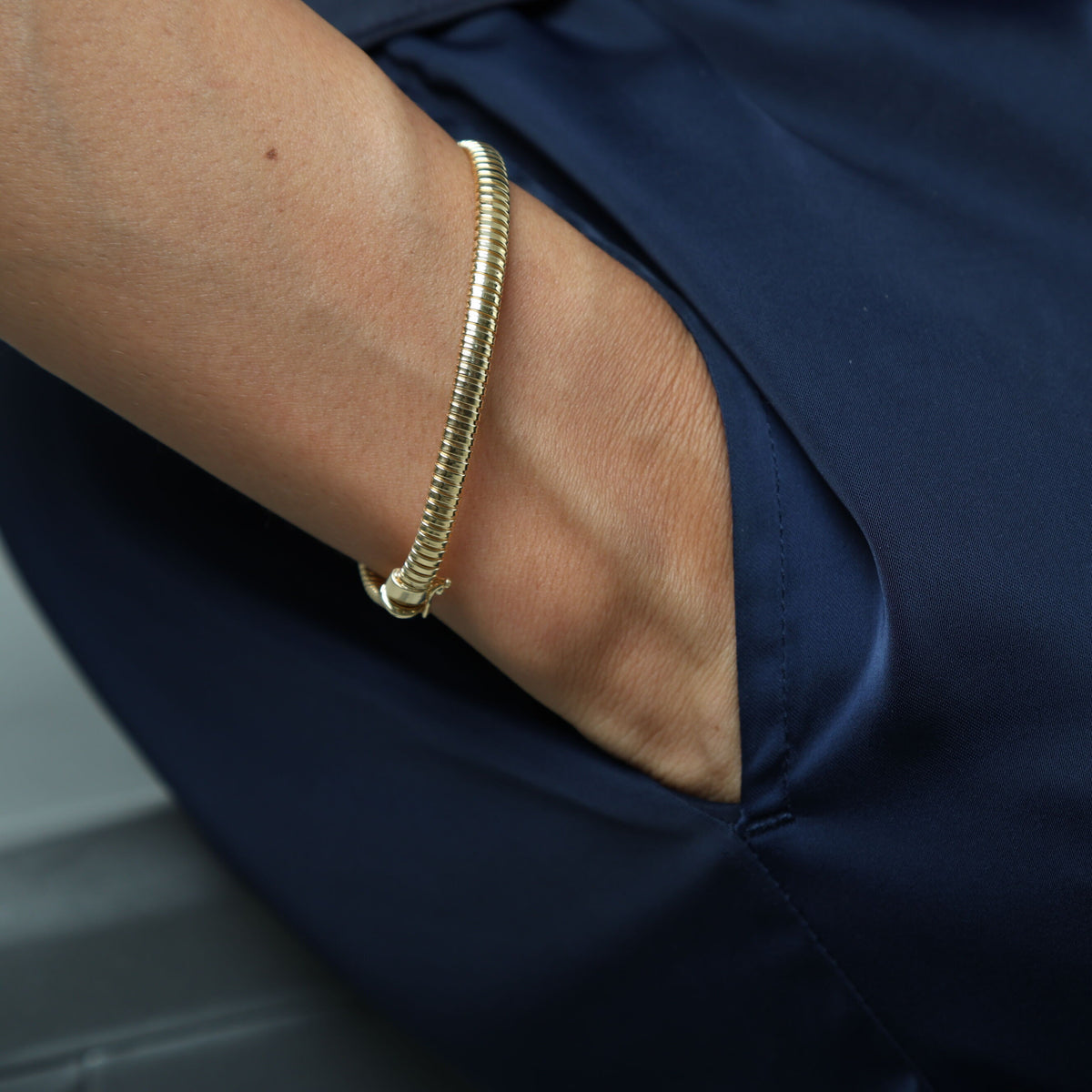 14K yellow gold Tubogas bracelet 7.25" length, 5mm width - close-up of flexible band and clasp, Made in Italy