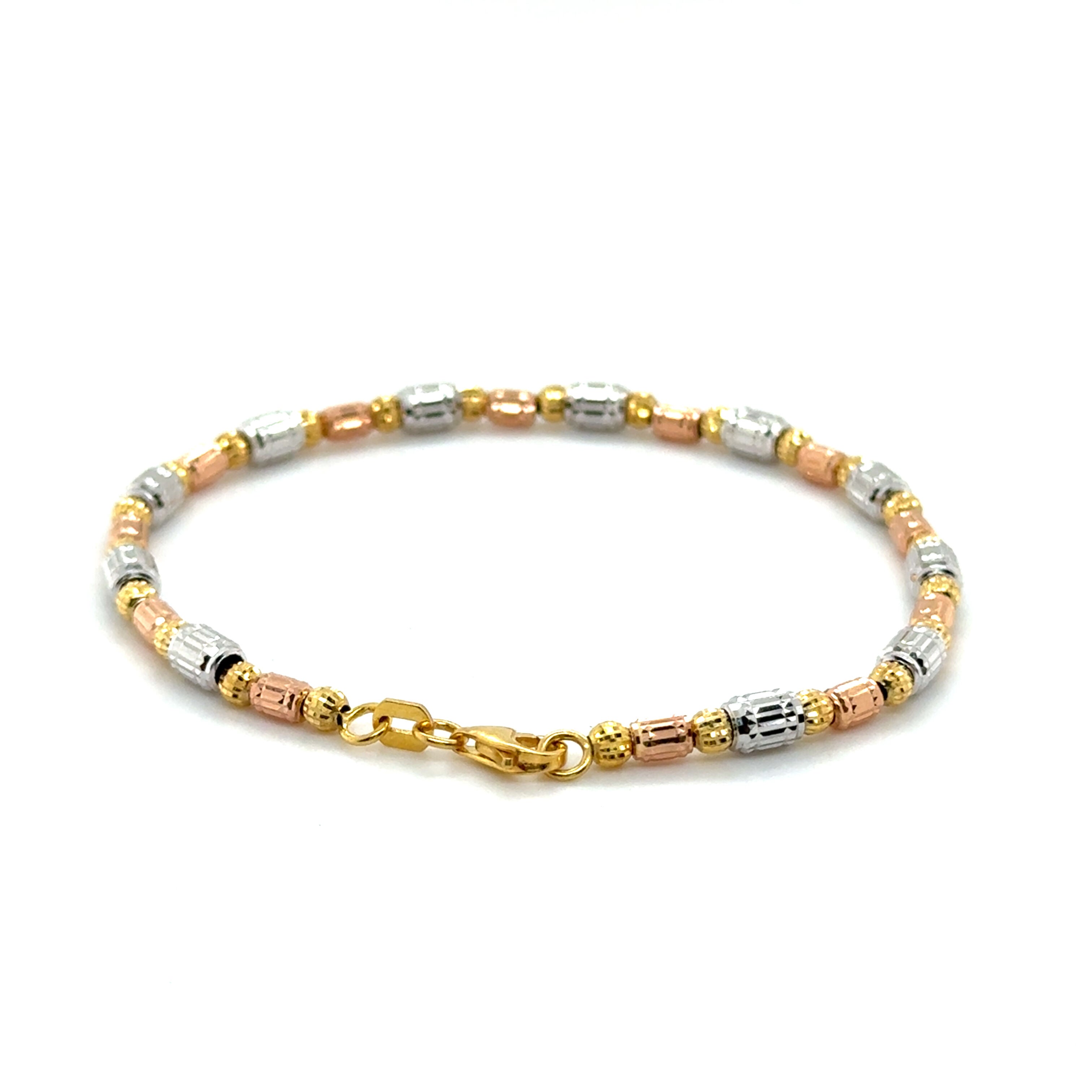 Elegant 14K Tricolor Gold Barrel Bracelet with diamond cut barrel beads offers tarnish resistant durability and a secure lobster clasp for comfortable fit. Ideal for timeless style.