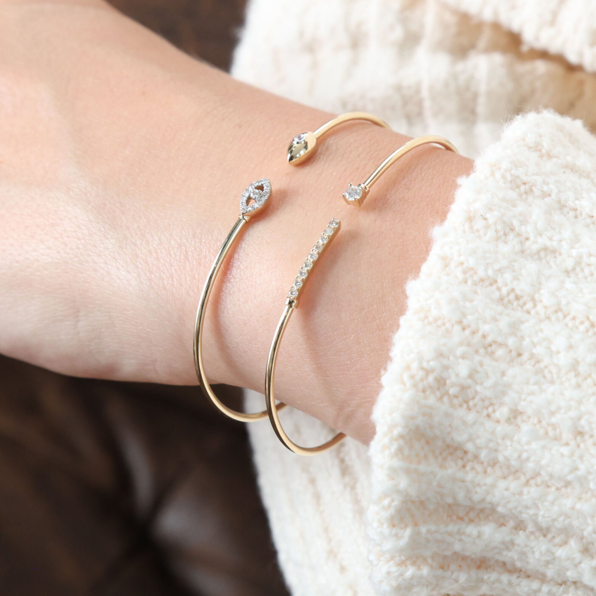 The Elegant Gold Diamond Cuff Bracelet adds a refined touch to any outfit, from casual attire to more formal wear. Paired with a cozy cream sweater, it’s ideal for bringing understated elegance to your look.