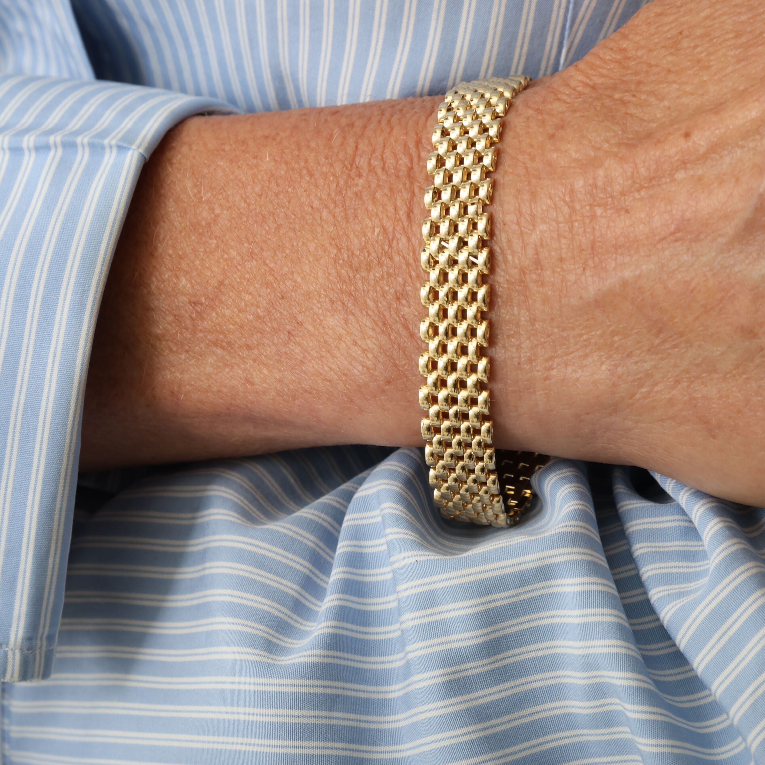 Panther Link Bracelet in 14K yellow gold worn solo with a neutral outfit, emphasizing sleek elegance and timeless appeal, perfect for anniversaries, birthdays, or minimalist evening styling.