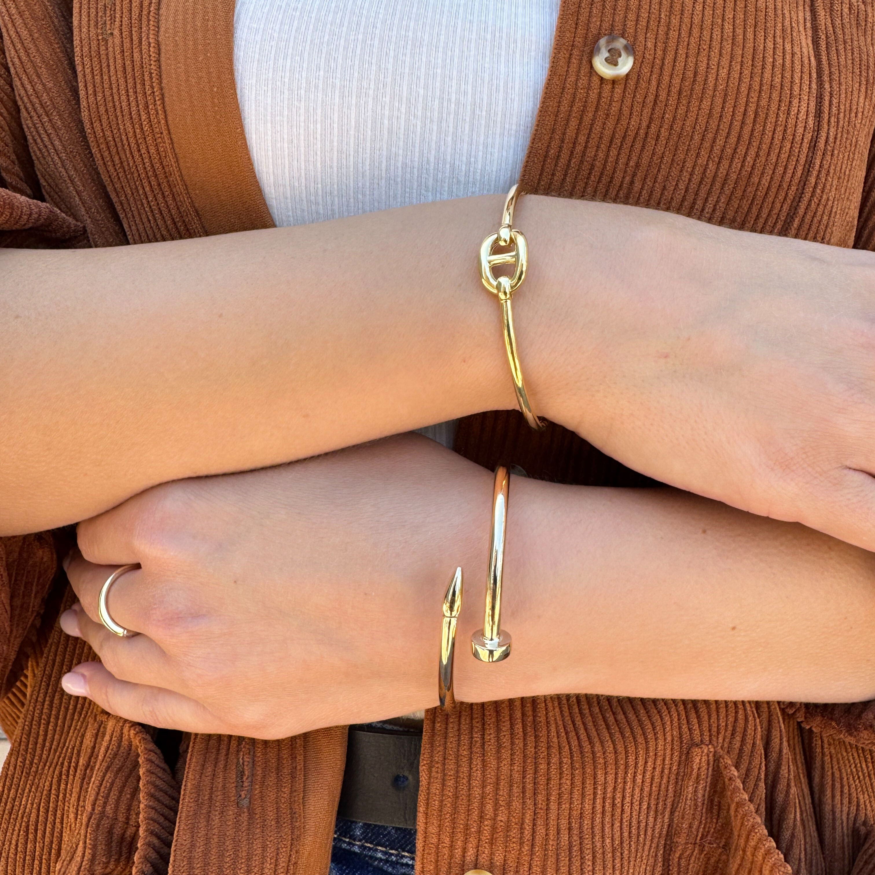 Sleek 14K gold mariner link bracelet worn on the wrist under natural sunlight, highlighting its polished finish and bold centerpiece. A timeless bracelet that radiates elegance for anniversaries, milestone celebrations, or evening gatherings.