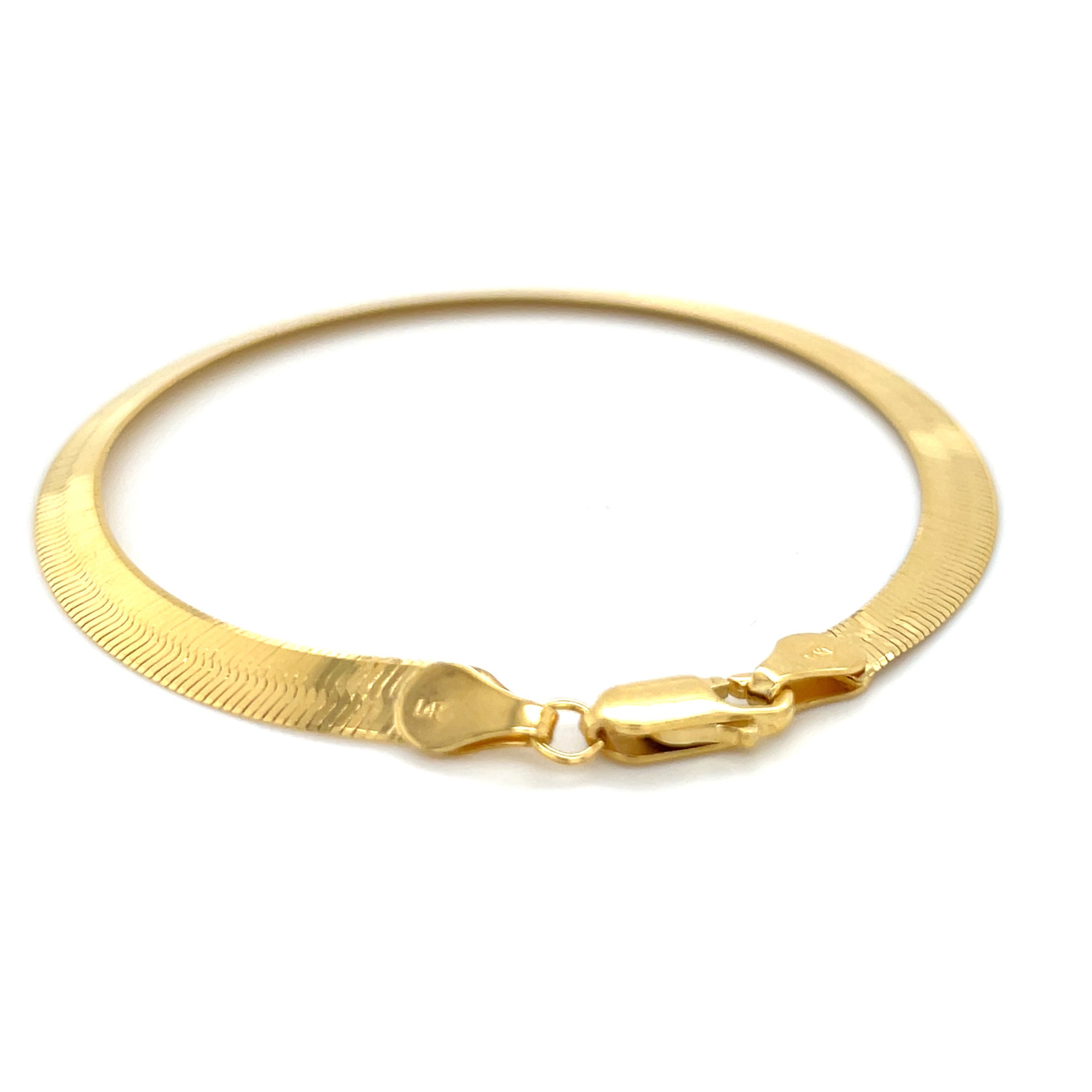 14K yellow gold herringbone bracelet with a sleek, luminous finish and flat chevron links that rest smoothly on the wrist. Elegant and comfortable for everyday wear, this bracelet is durable, tarnish-resistant, and secured with a sturdy lobster claw clasp. A timeless fine jewelry gift for birthdays, anniversaries, weddings, or milestone celebrations.
