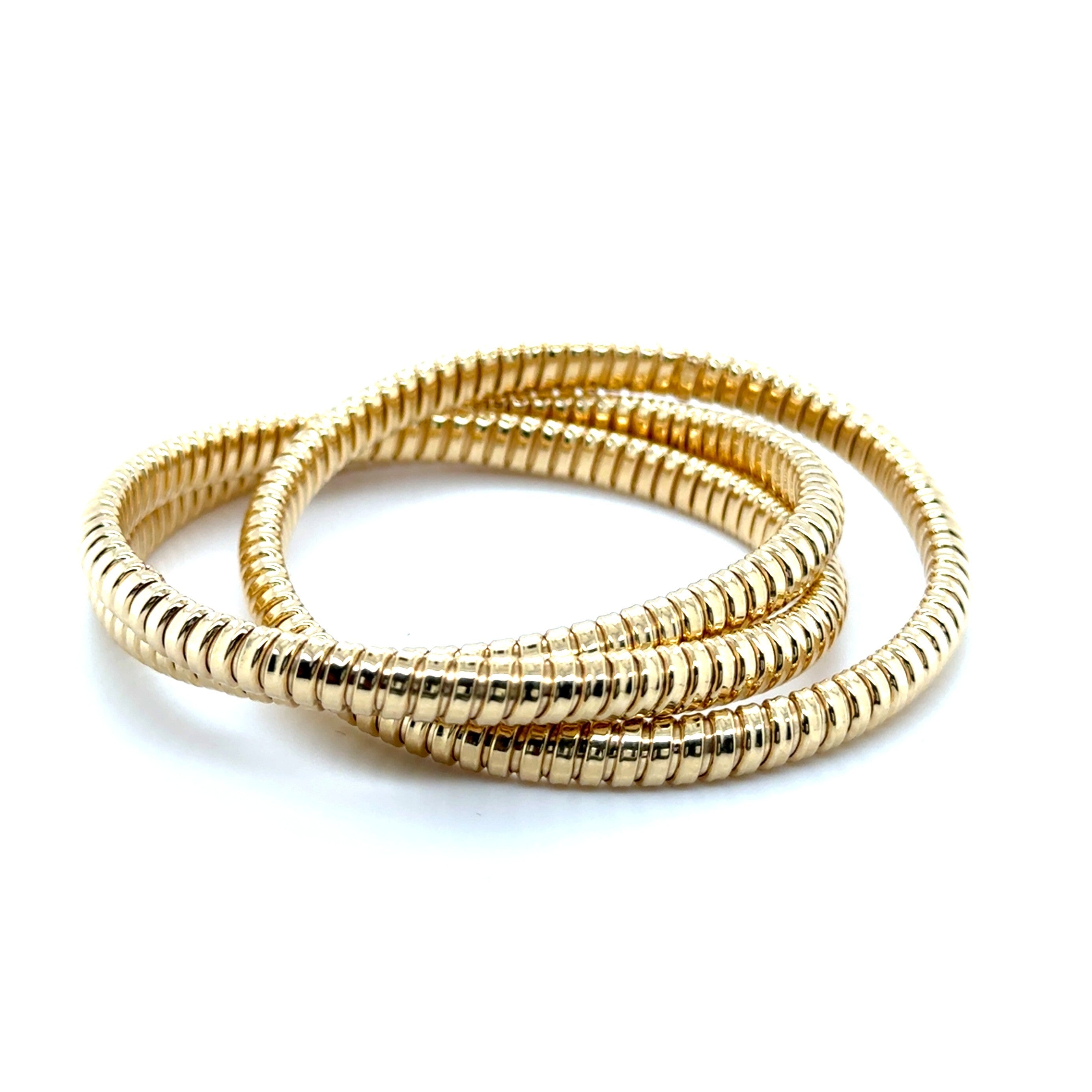 14K yellow gold Tubogas bangle with a polished coiled design, offering timeless elegance and everyday comfort. Substantial yet flexible, this bold bracelet is perfect for birthdays, anniversaries, milestone celebrations, or as a versatile luxury accessory.