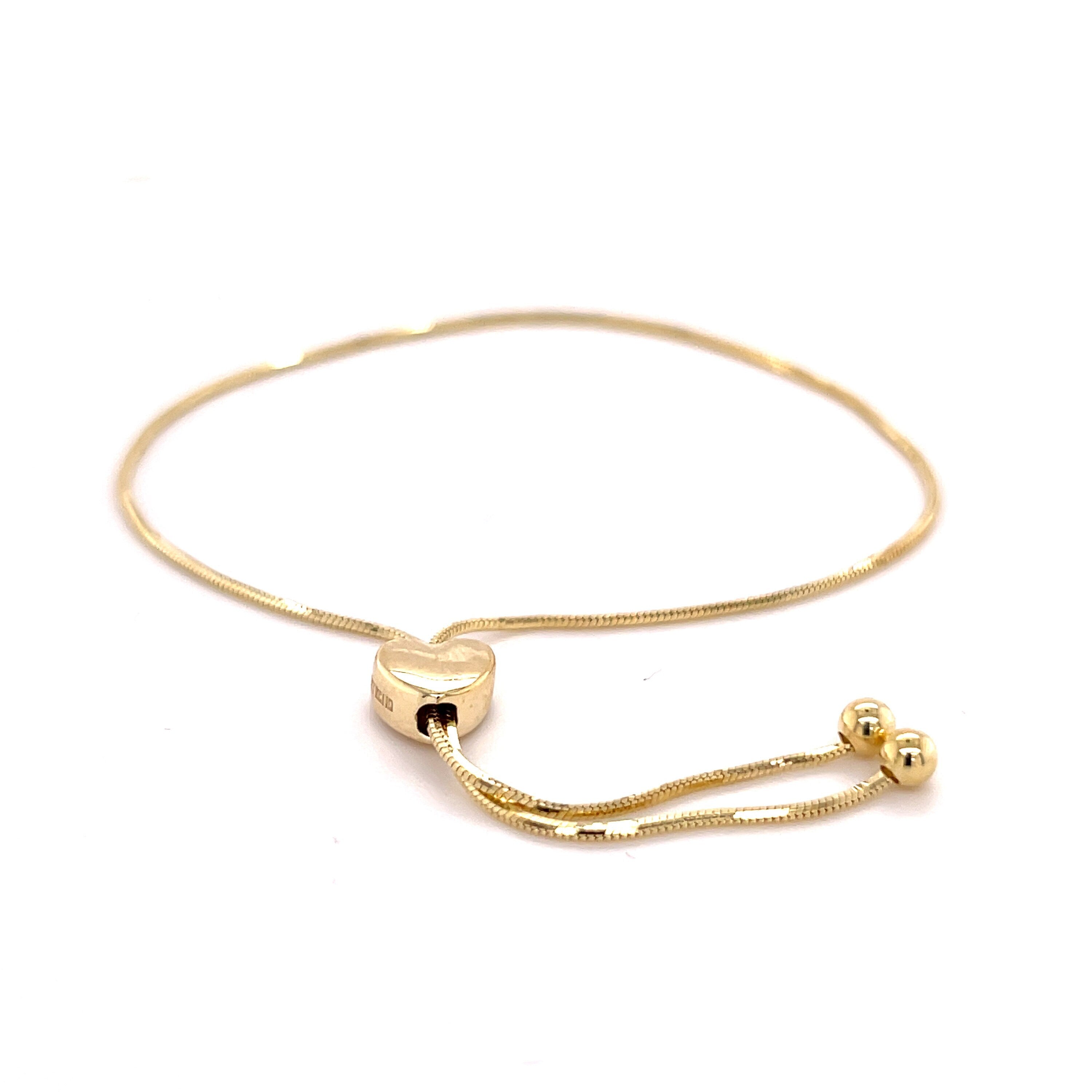 This 14K Yellow Gold Bracelet features a heart-shaped slider and ultra-thin 1mm chain, ideal for meaningful gifts and delicate wrist layering