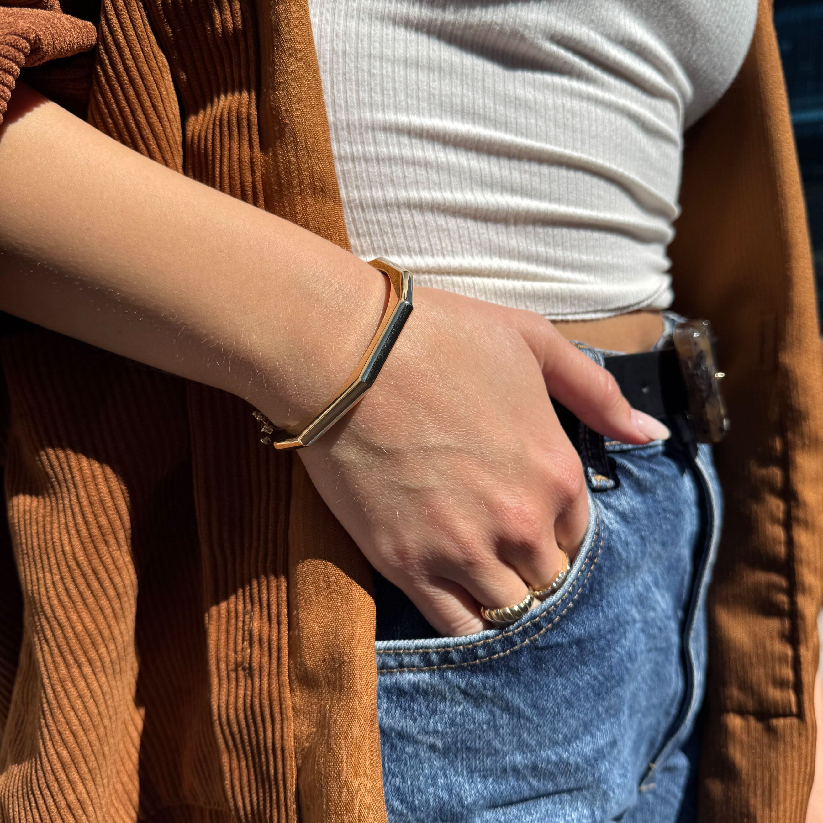 14K Gold Octagonal Bracelet complements her warm cardigan and layered gold accessories, adding edge and elegance for effortless daytime styling.
