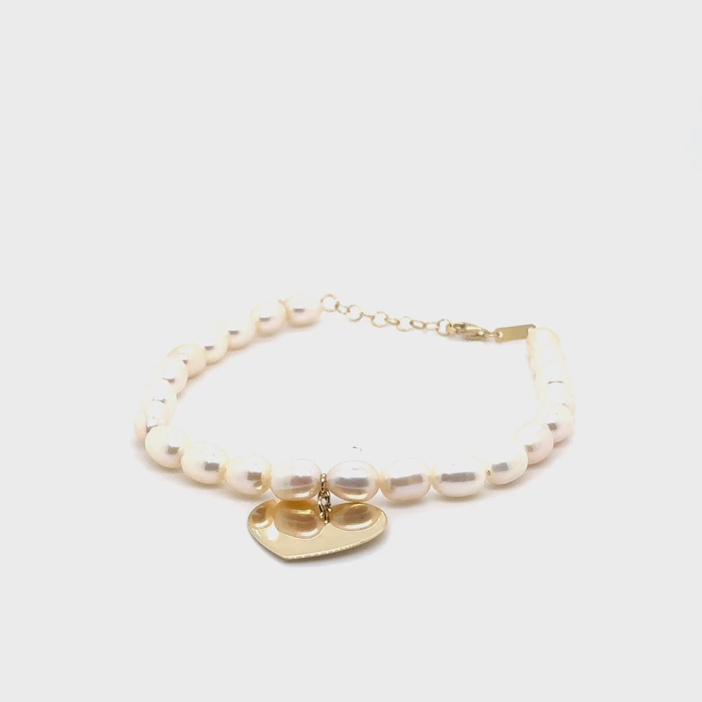 Pearl Bracelet with Heart Charm in 14K solid gold, crafted with luminous freshwater pearls and a polished engravable gold heart. This elegant and timeless jewelry style is durable, versatile, and meaningful, making it a thoughtful gift idea for anniversaries, birthdays, or milestone celebrations. Perfect to wear for weddings, parties, and everyday luxury style.