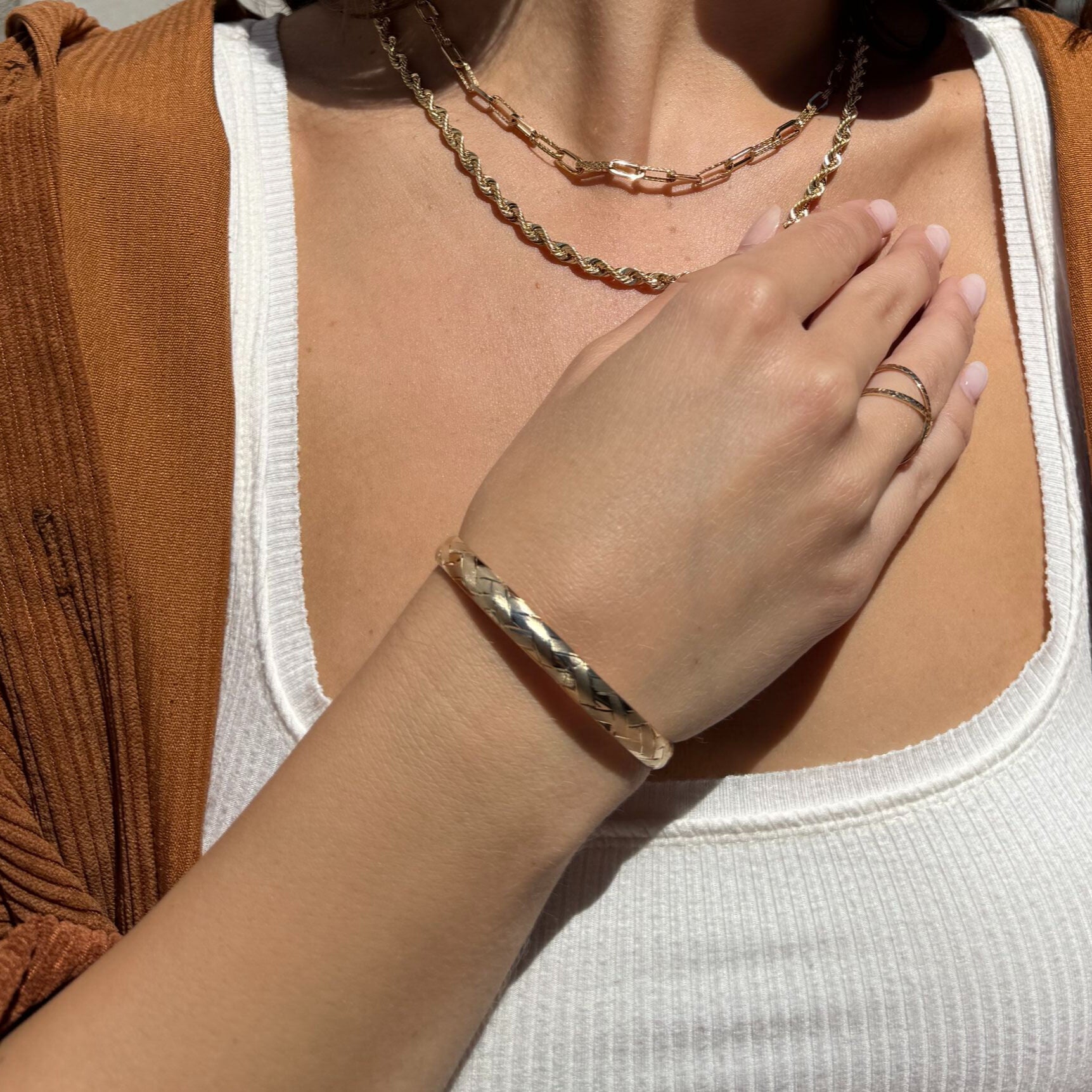 Polished 14K Gold Basketweave Bangle styled with denim jeans and a ribbed white tank, offering a balanced statement for casual gold lovers