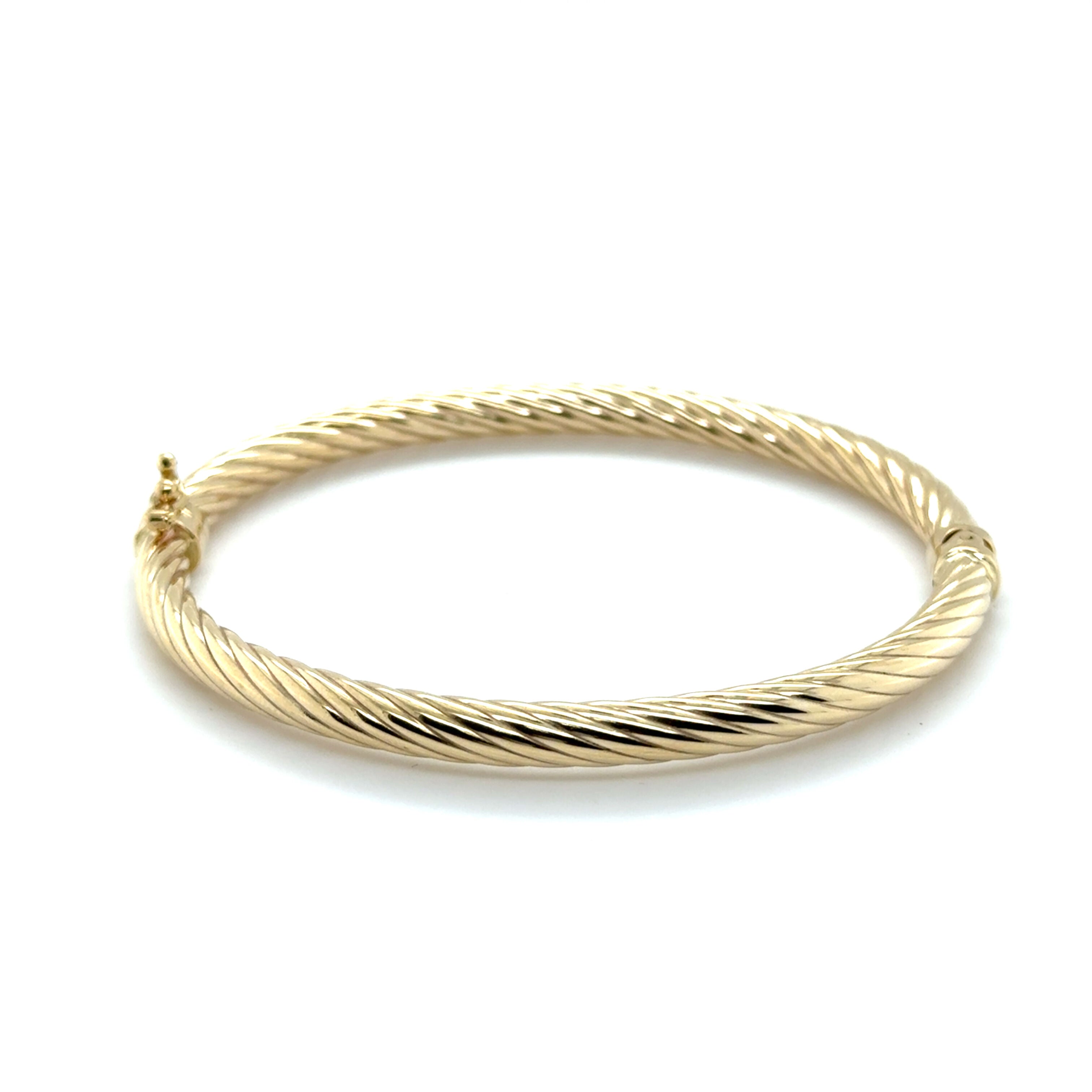 Textured yellow gold twist bangle styled for stacking, adds visual interest and classic appeal, ideal for birthdays or thank-you gifts