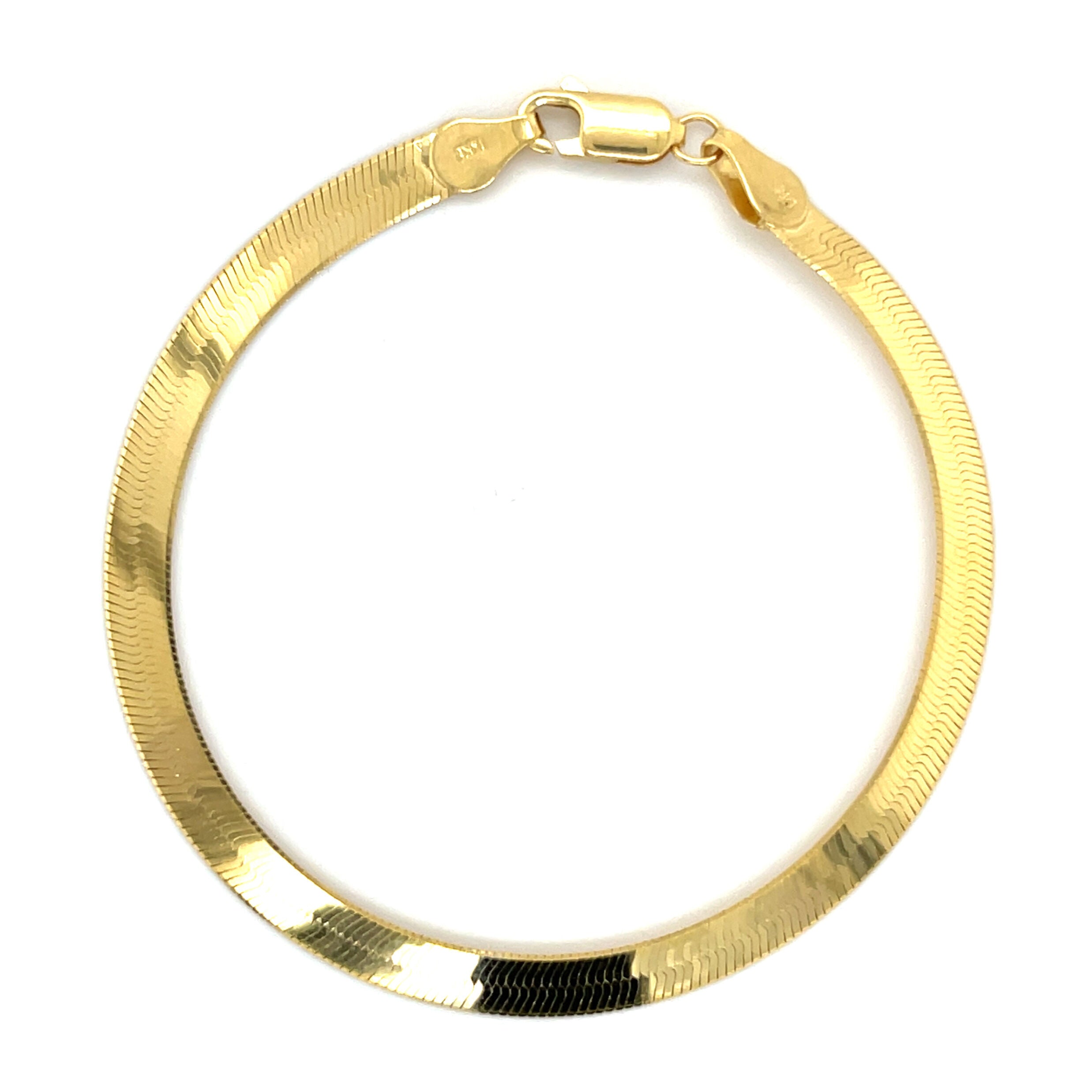 14K yellow gold herringbone bracelet with a sleek, luminous finish and flat chevron links that rest smoothly on the wrist. Elegant and comfortable for everyday wear, this bracelet is durable, tarnish-resistant, and secured with a sturdy lobster claw clasp. A timeless fine jewelry gift for birthdays, anniversaries, weddings, or milestone celebrations.