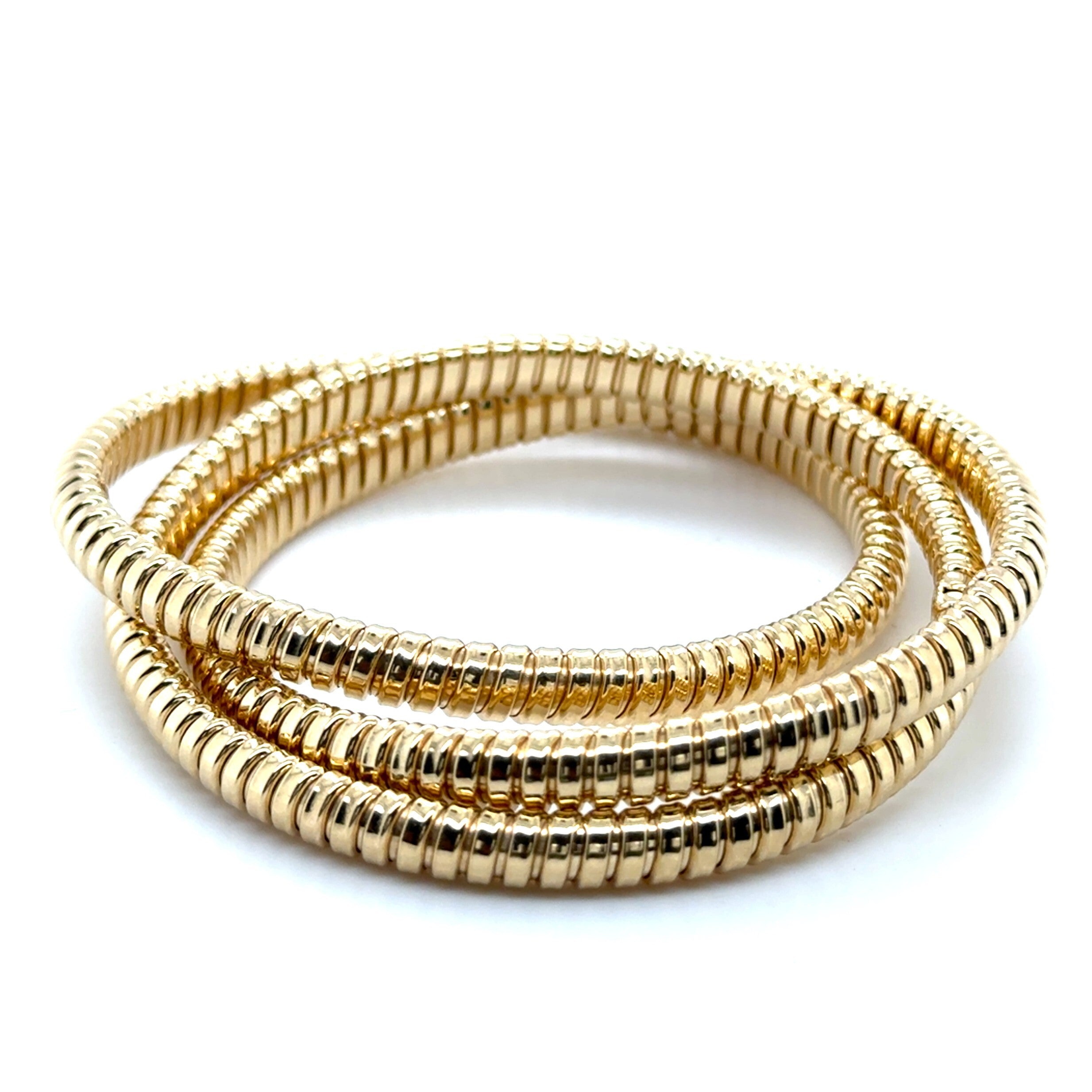 14K yellow gold Tubogas bangle with a polished coiled design, offering timeless elegance and everyday comfort. Substantial yet flexible, this bold bracelet is perfect for birthdays, anniversaries, milestone celebrations, or as a versatile luxury accessory.