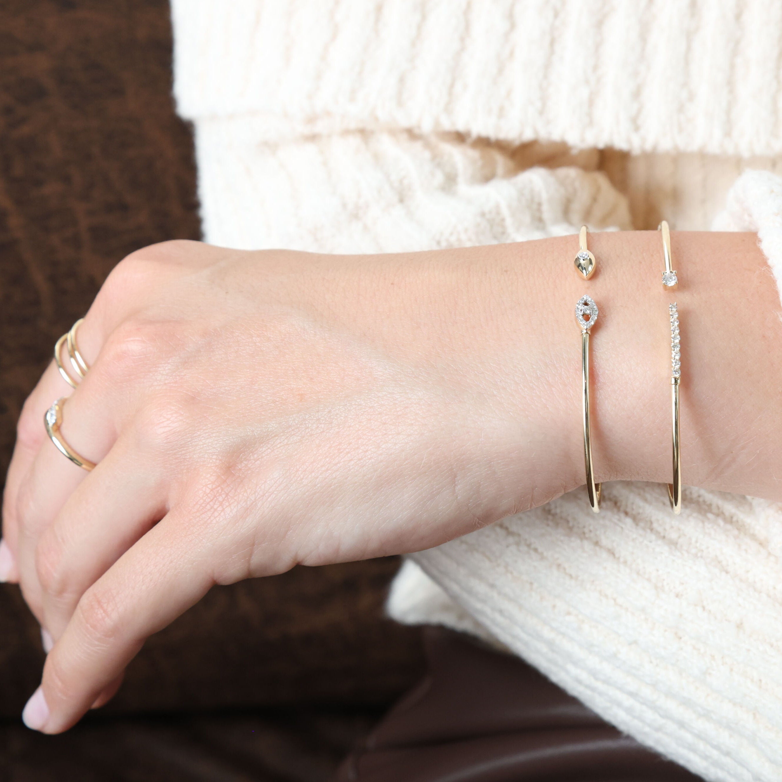 Paired with a chic brown dress, this 14K Yellow Gold Diamond Cuff Bangle enhances the outfit with its sleek design and sparkling diamonds. Perfect for a dinner date or evening event, this bracelet adds a refined touch.