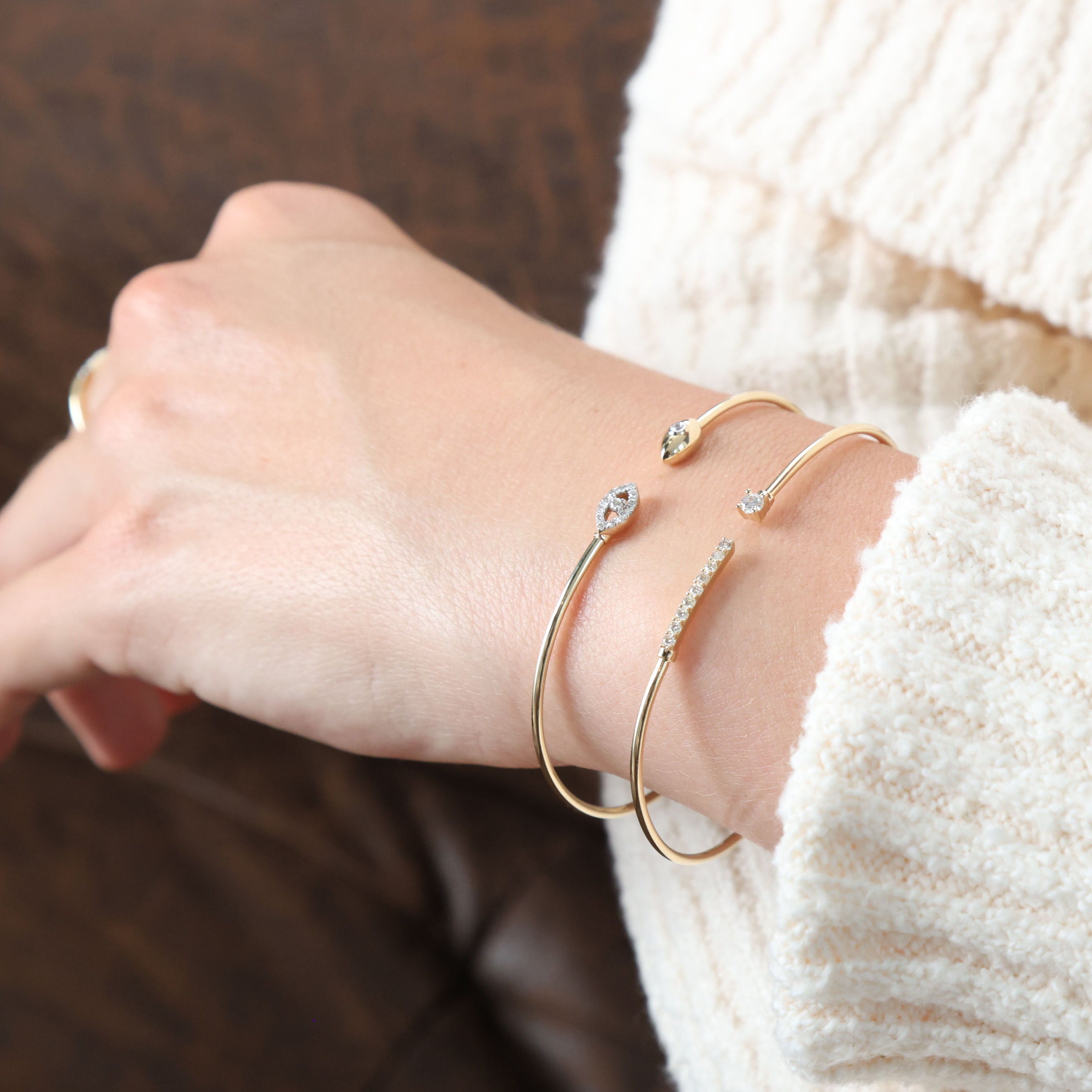 Worn with a simple white blouse, the 14K Yellow Gold Diamond Bar Cuff Bangle Bracelet adds a touch of elegance to an everyday outfit. Its sparkling diamonds and sleek design make it perfect for casual meetings or brunch dates.