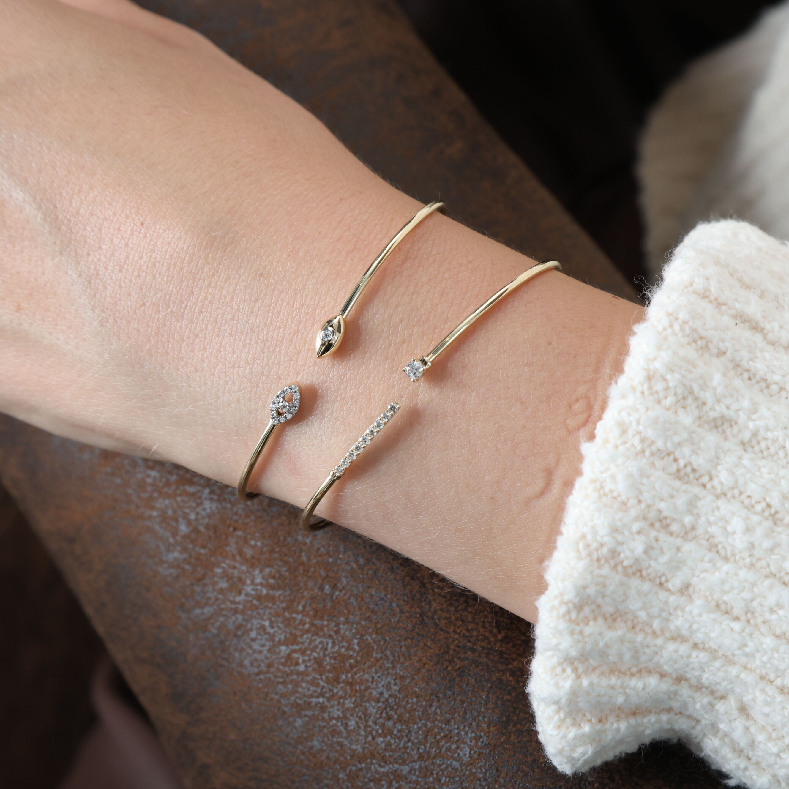 Styled with a cozy cream sweater, this 14K Yellow Gold Diamond Open Cuff Bangle adds subtle elegance to a relaxed look. Its minimalistic design and delicate diamonds make it perfect for daily wear or a casual gathering.