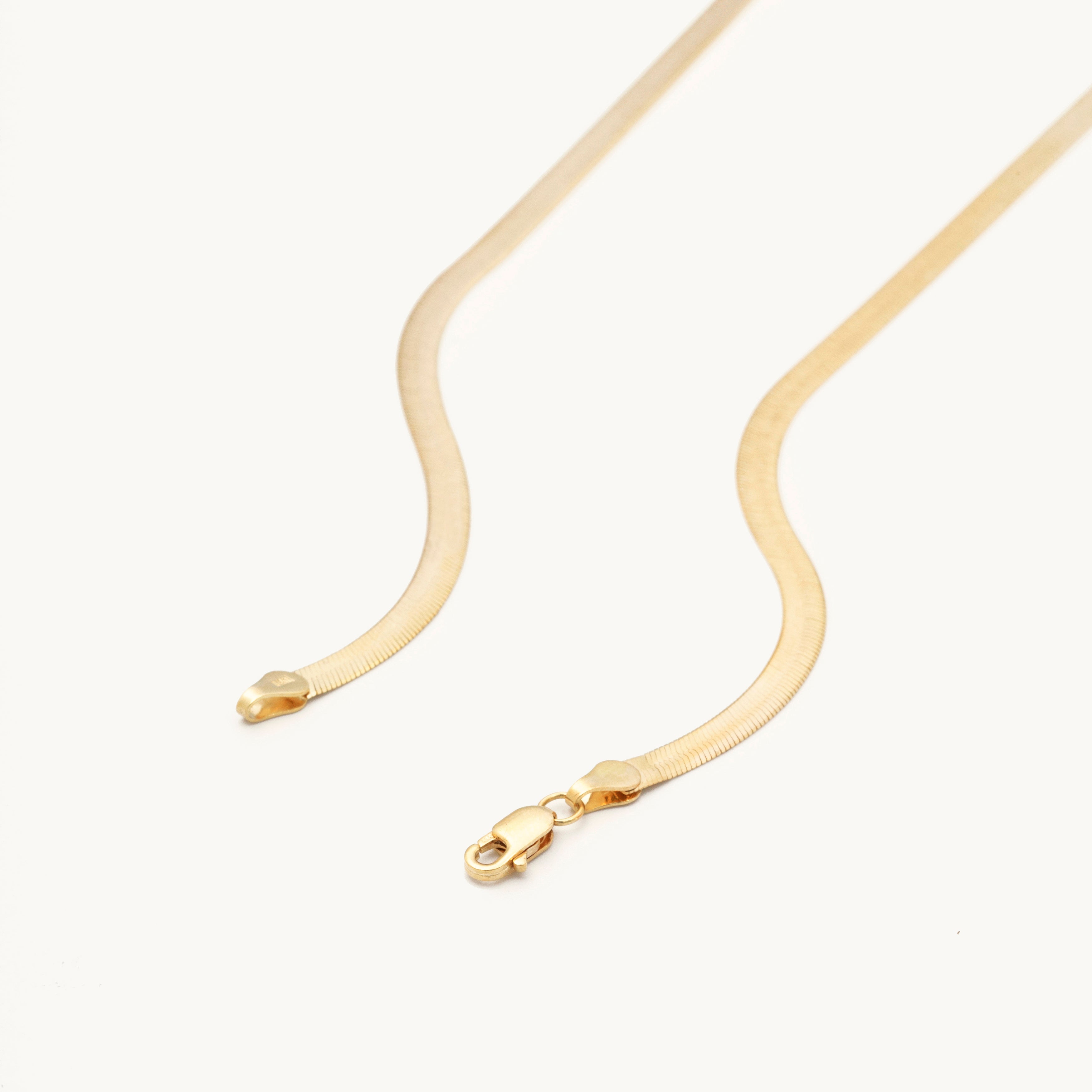 14K Solid Yellow Gold Herringbone Necklace featuring a bold flat-link design with a polished, mirror-like shine. This elegant and timeless solid gold necklace is durable, comfortable, and versatile for everyday wear or layering, making it an ideal gift for birthdays, anniversaries, weddings, and milestone celebrations.