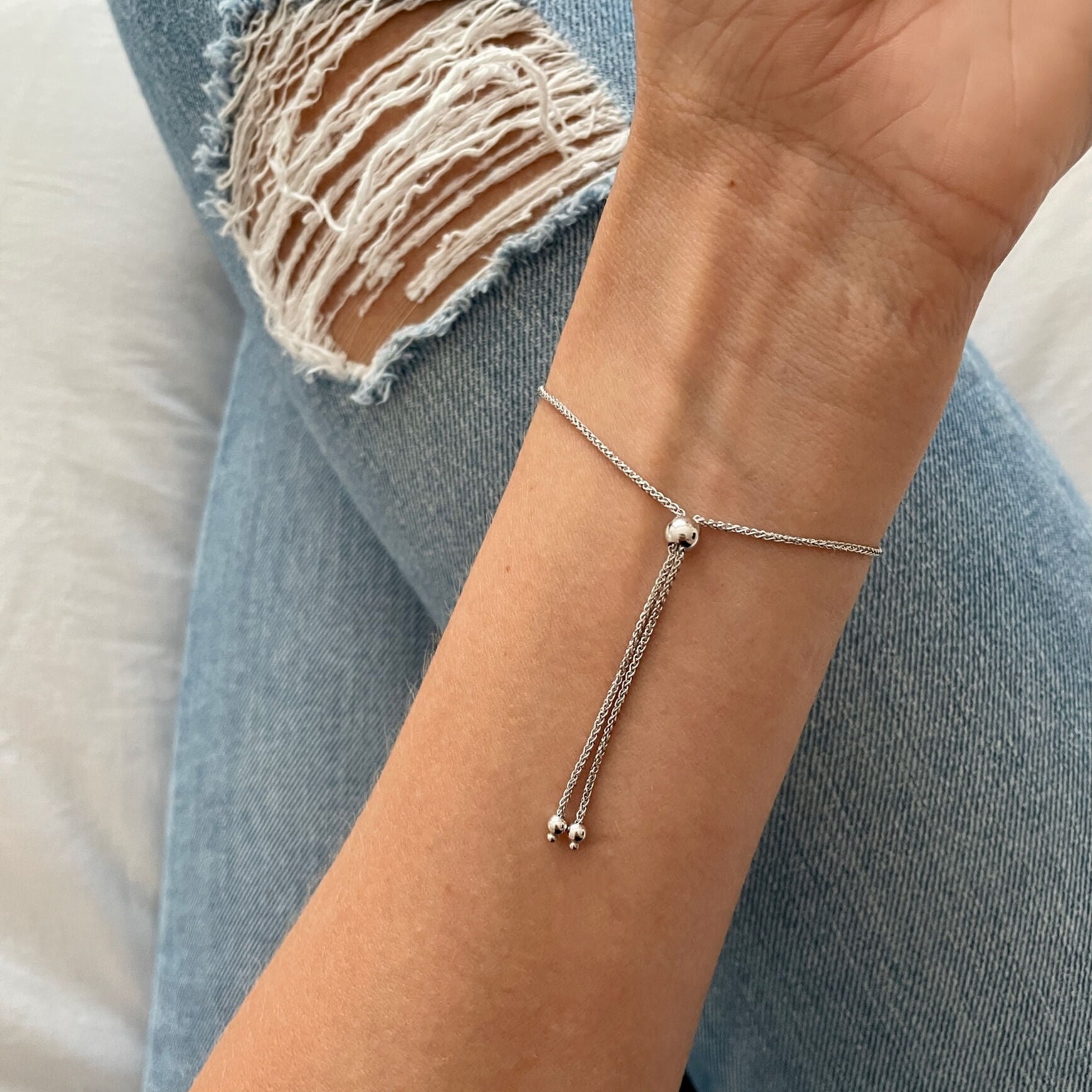 Curved Gold Bracelet paired with oatmeal-toned sweater layers and subtle makeup, ideal for soft winter outfits or neutral-toned minimalist styling