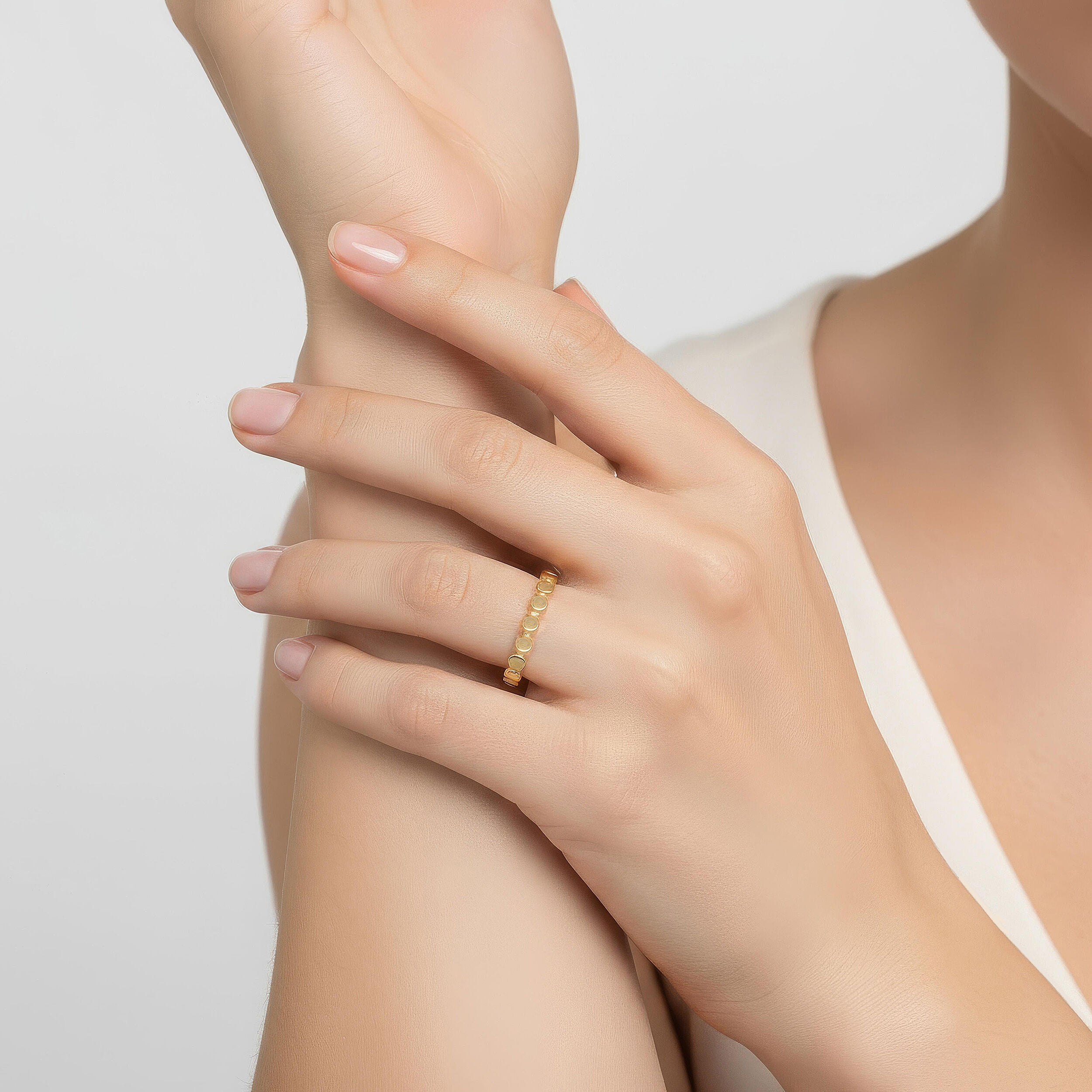 14K yellow gold flat disc ring styled on hand featuring delicate gold disc details