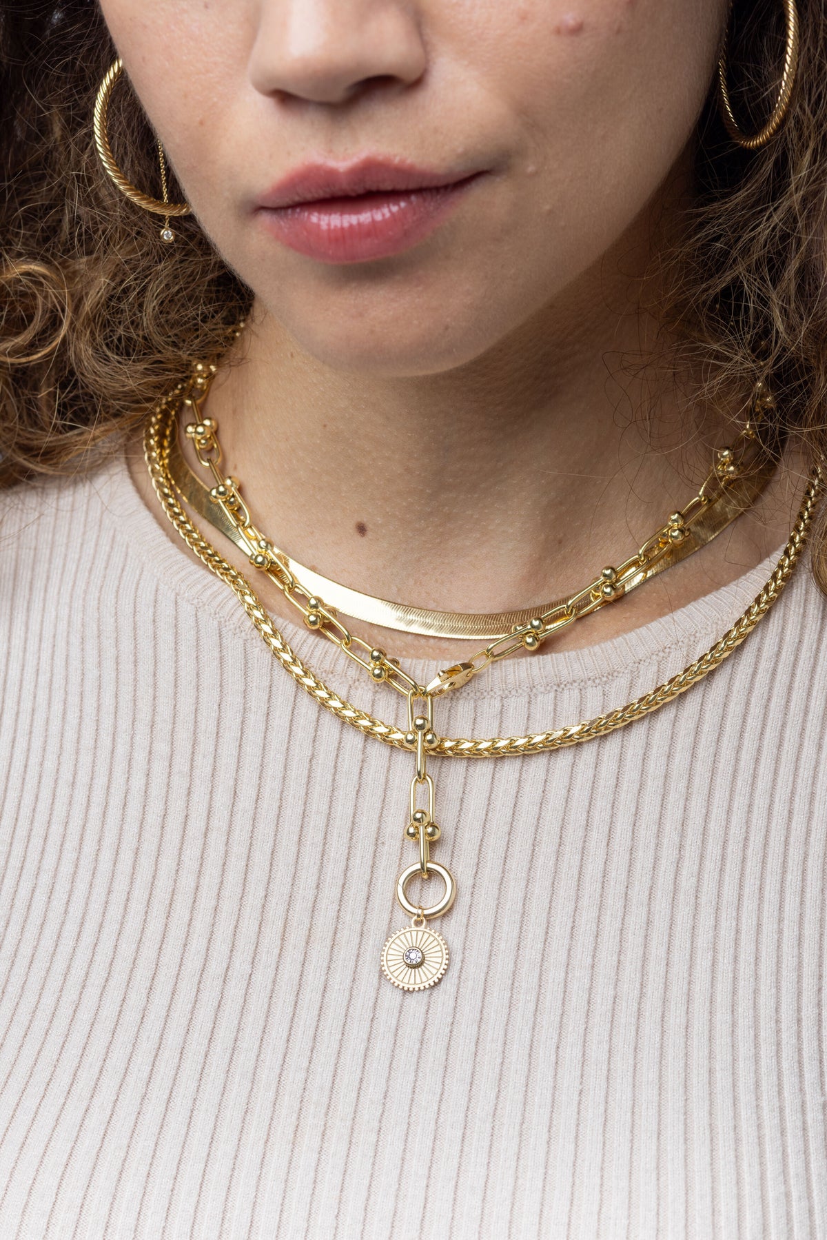14K yellow gold round wheat chain necklace with diamond-cut finish coiled on black velvet to showcase sparkle