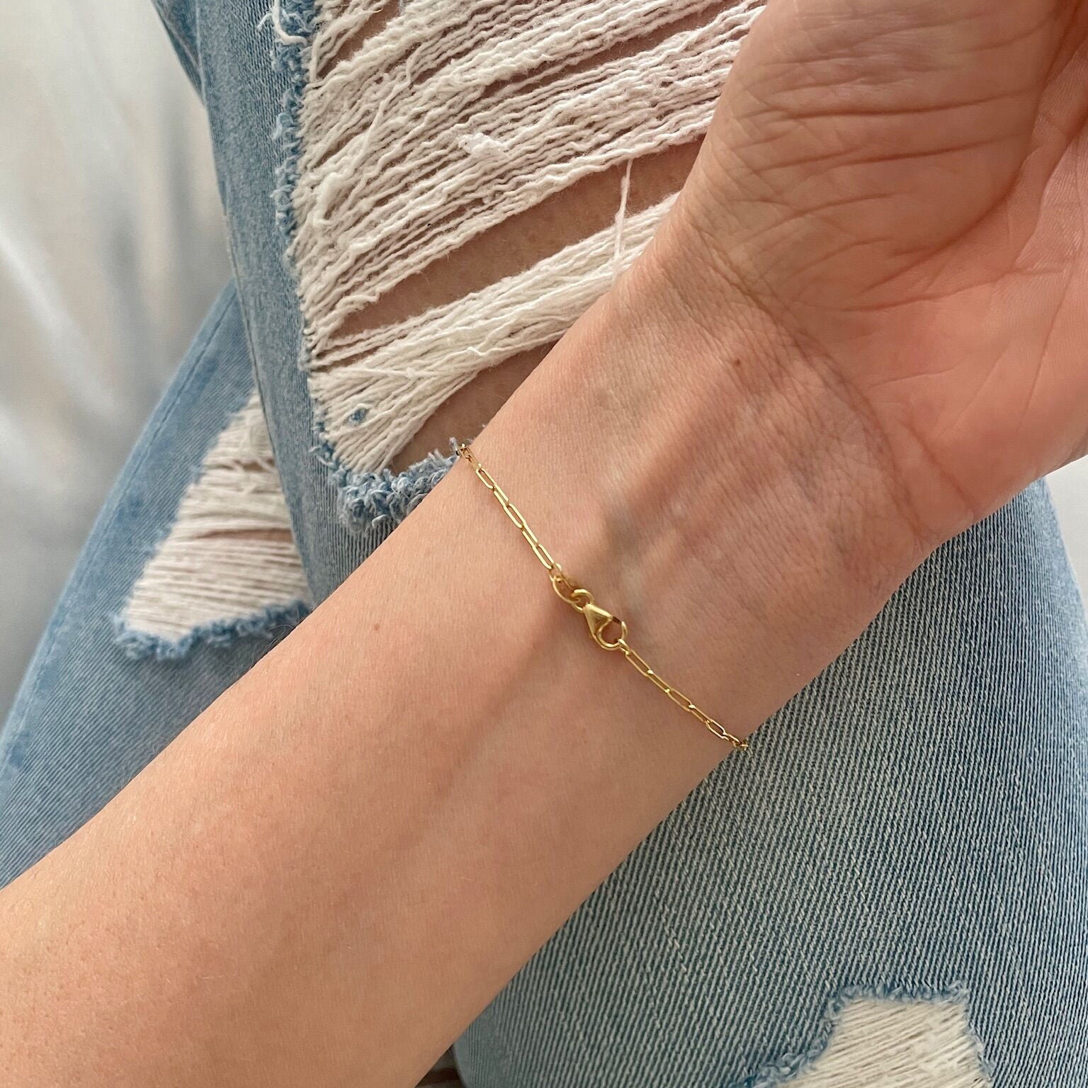 Dainty 14K gold Blue Topaz bracelet worn on the wrist under natural light, highlighting the December birthstone’s brilliance. A delicate accessory that enhances confidence and clarity, ideal for workdays, study sessions, or weekend outings.