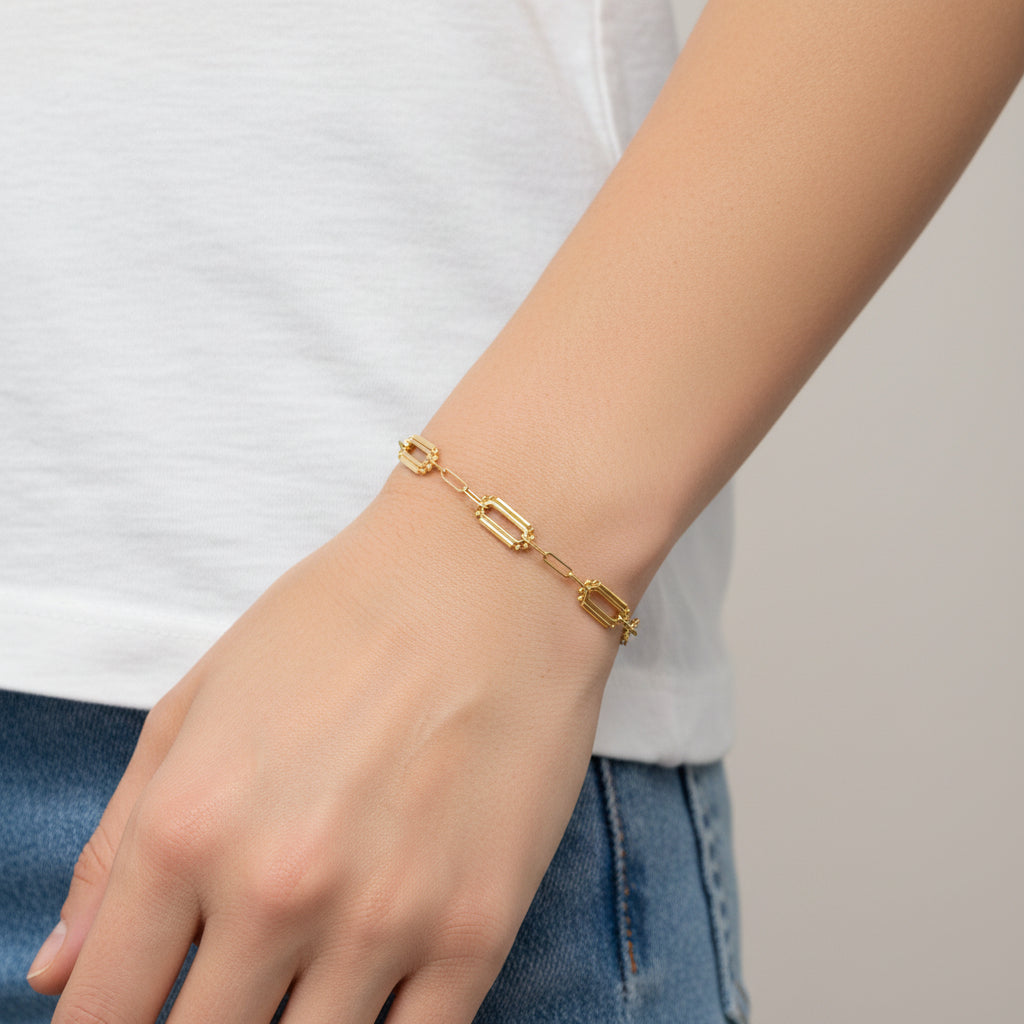 14k yellow Gold mixed link paperclip chain bracelet on a white background