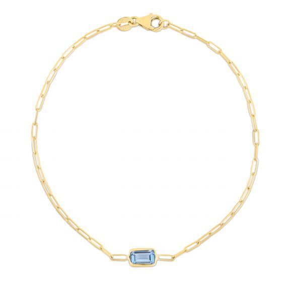 A dainty 14K gold paperclip bracelet featuring a baguette-cut Blue Topaz centerpiece, the December birthstone symbolizing honesty and clarity. This elegant and minimalist design is durable, versatile, and comfortable for everyday wear, making it a meaningful gift for birthdays, anniversaries, or milestone celebrations.