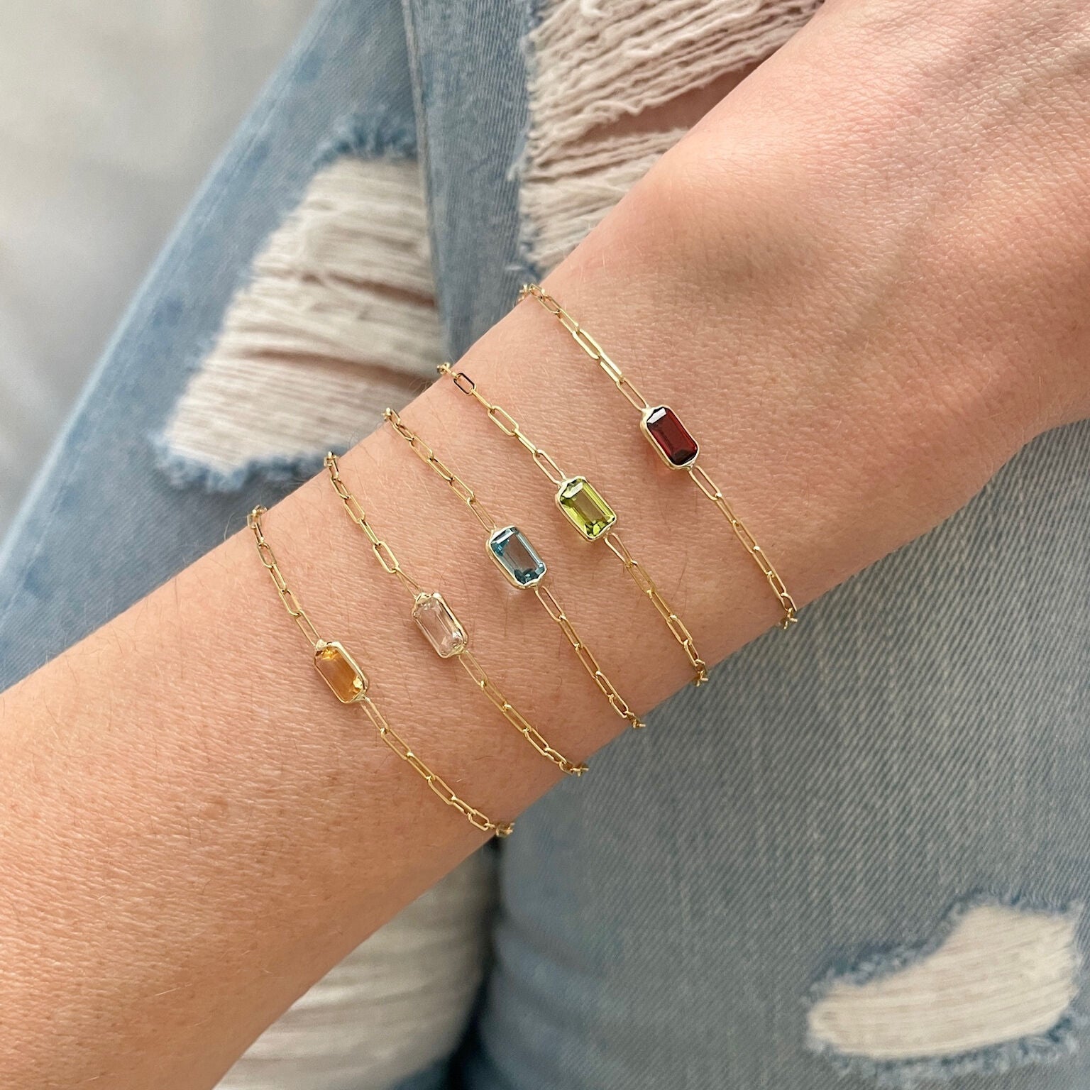 Dainty Blue Topaz December birthstone bracelet styled with light neutral clothing, creating a calm and timeless look. A versatile jewelry piece that adds sparkle for anniversaries, milestone celebrations, or everyday wear.