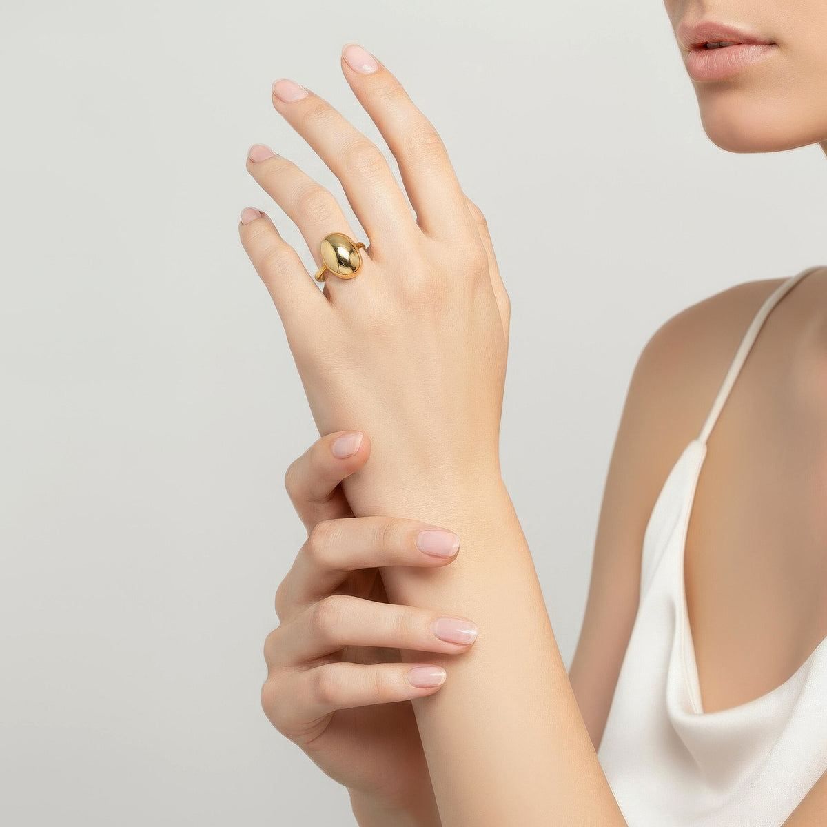 14K gold puffy oval ring styled on hand with smooth sculptural design and modern statement jewelry look