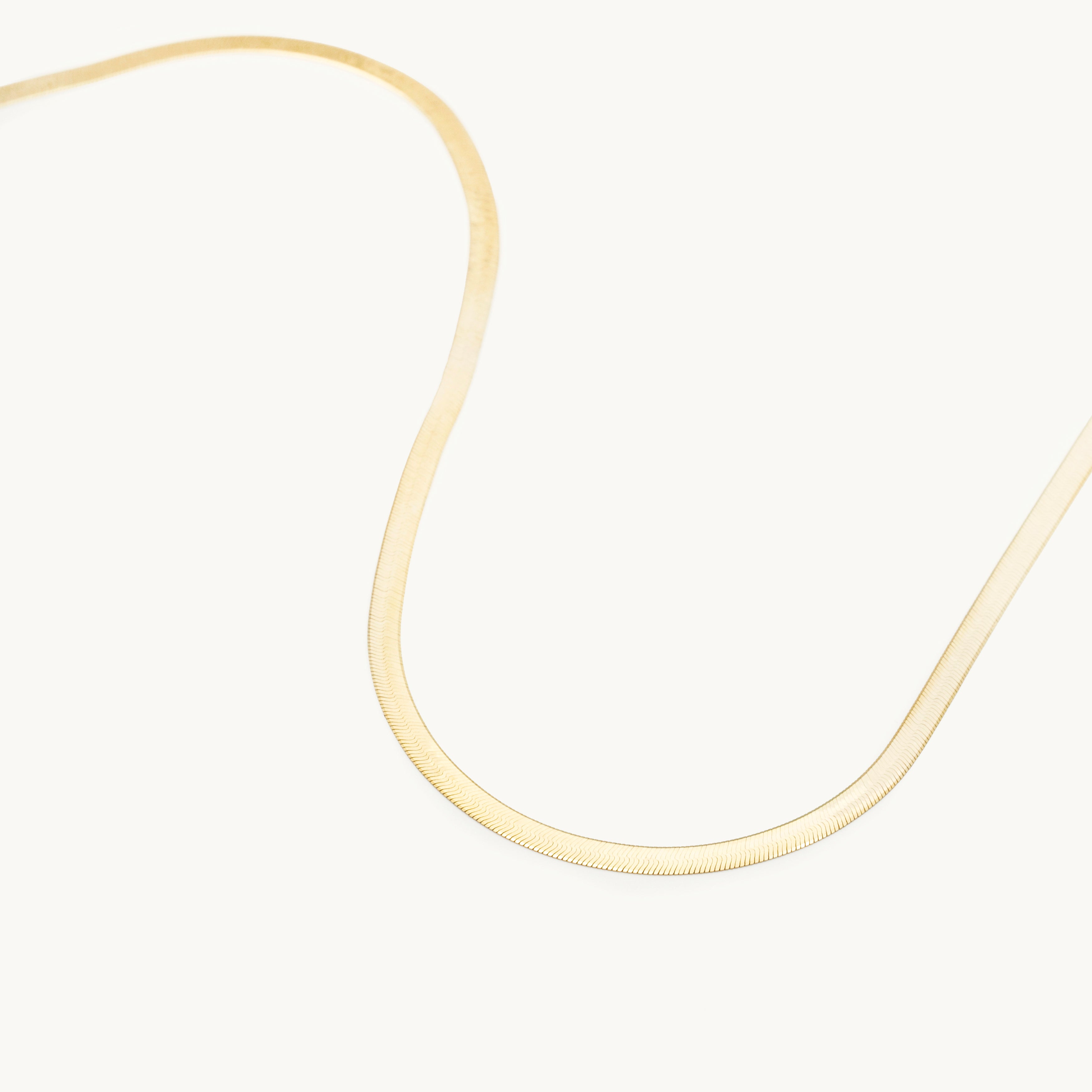 14K Solid Yellow Gold Herringbone Necklace featuring a bold flat-link design with a polished, mirror-like shine. This elegant and timeless solid gold necklace is durable, comfortable, and versatile for everyday wear or layering, making it an ideal gift for birthdays, anniversaries, weddings, and milestone celebrations.