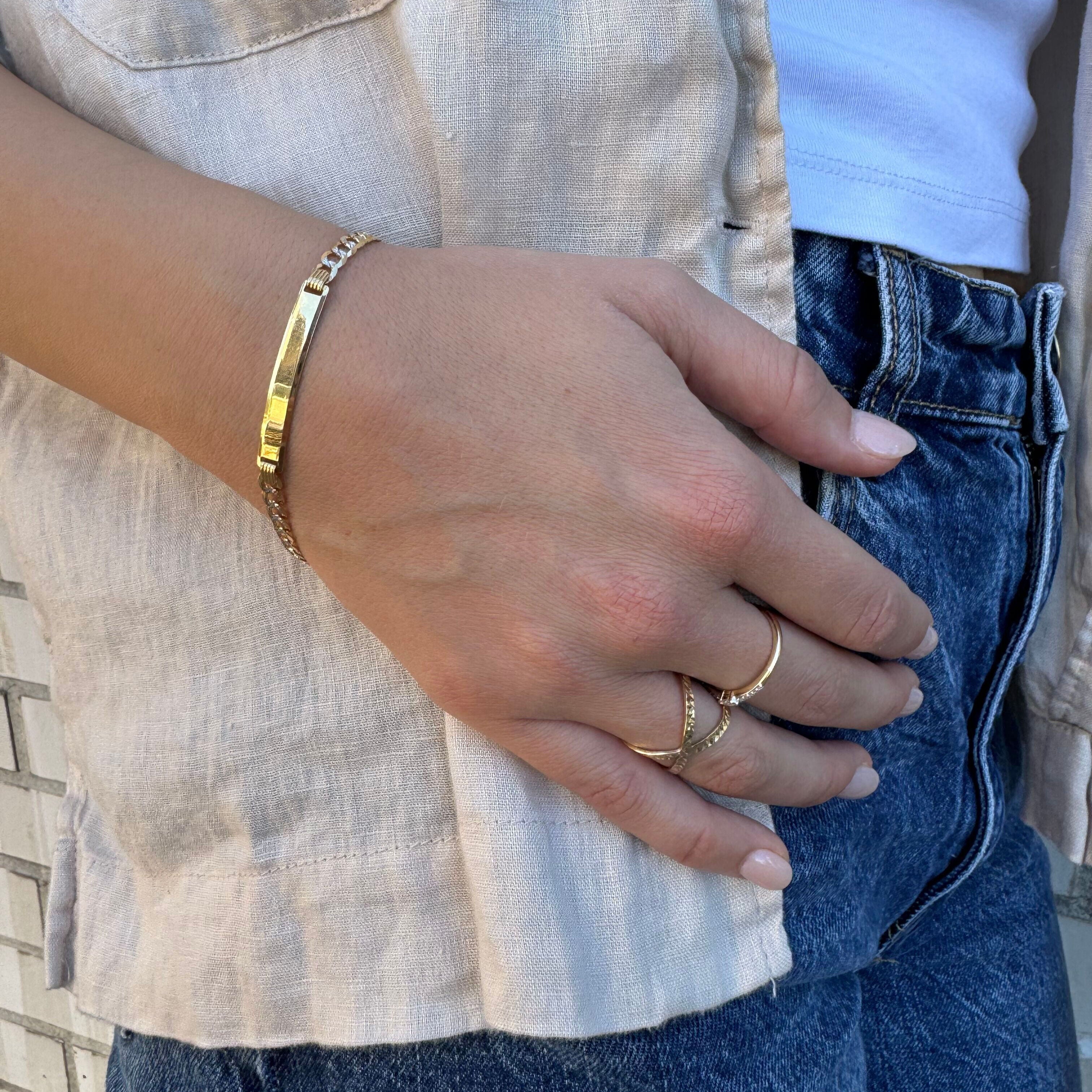 14K Two Tone Gold Curb Link Bracelet styled with neutral tones and a tailored look, giving a polished and confident impression. Perfect for office wear, anniversaries, or celebratory dinners.