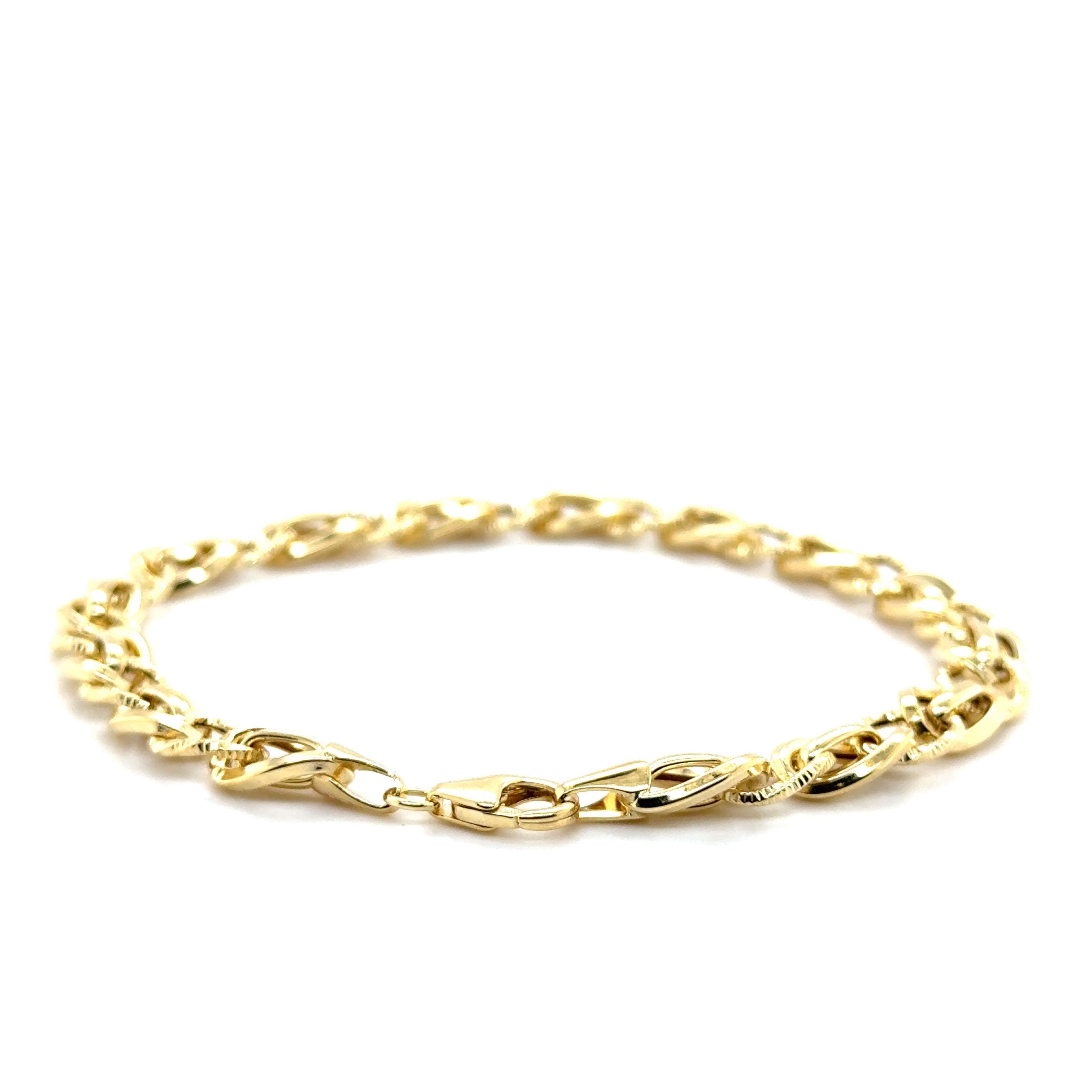 14K solid gold twisted oval link bracelet with polished, textured connectors, offering a bold yet elegant style. Durable and tarnish-resistant, this bracelet is perfect for everyday wear or evenings, and makes a thoughtful gift for birthdays, anniversaries, and milestone celebrations.