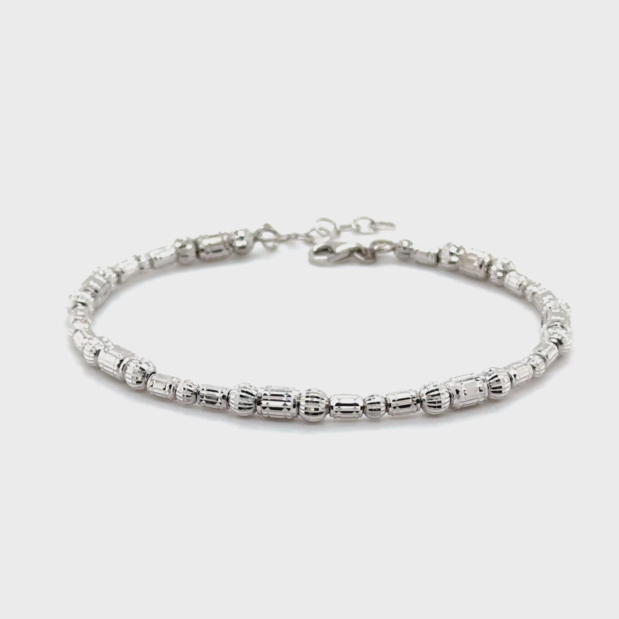 Elegant 14K White Gold Barrel Bracelet with diamond cut beads provides a tarnish resistant design and a secure lobster clasp for everyday comfort.