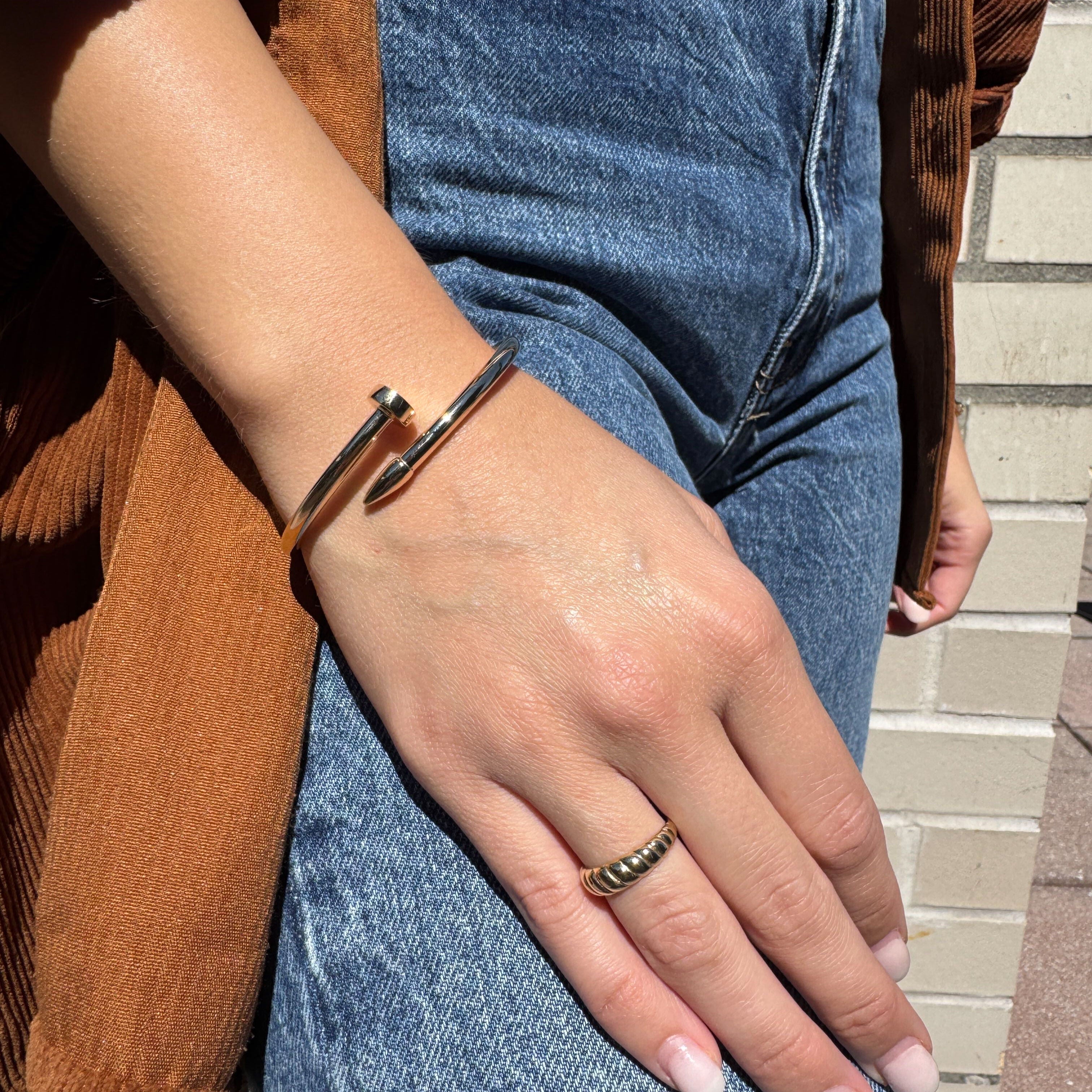 The 14K Gold Wrap Bangle completes a casual yet elevated stack, perfect for transitional outfits, reflecting strength and ideal for birthdays or new chapters.
