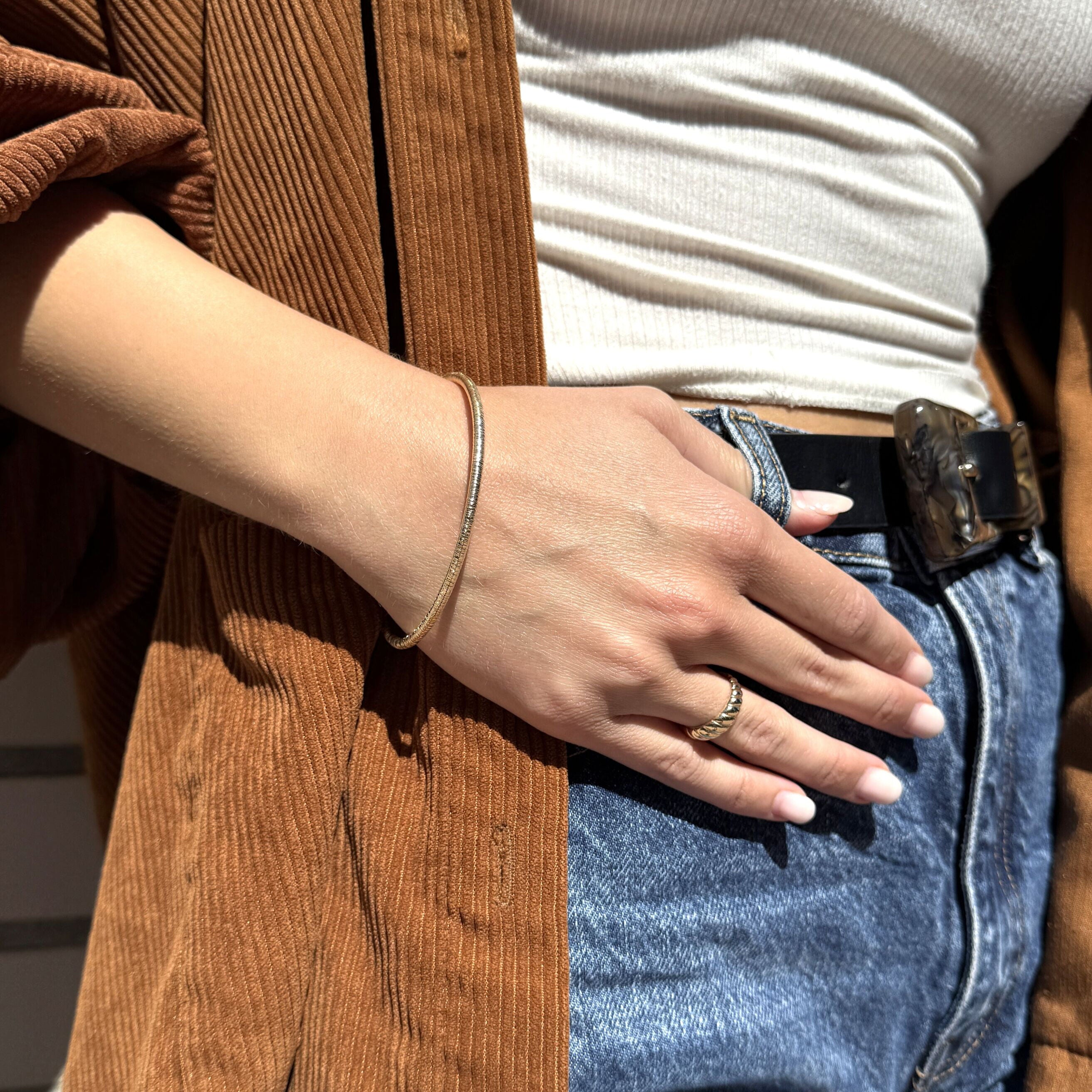 Textured 14K Gold Bangle shown with layered casual outfit and jeans, offering sleek femininity and a versatile gift for sisters or minimalists.